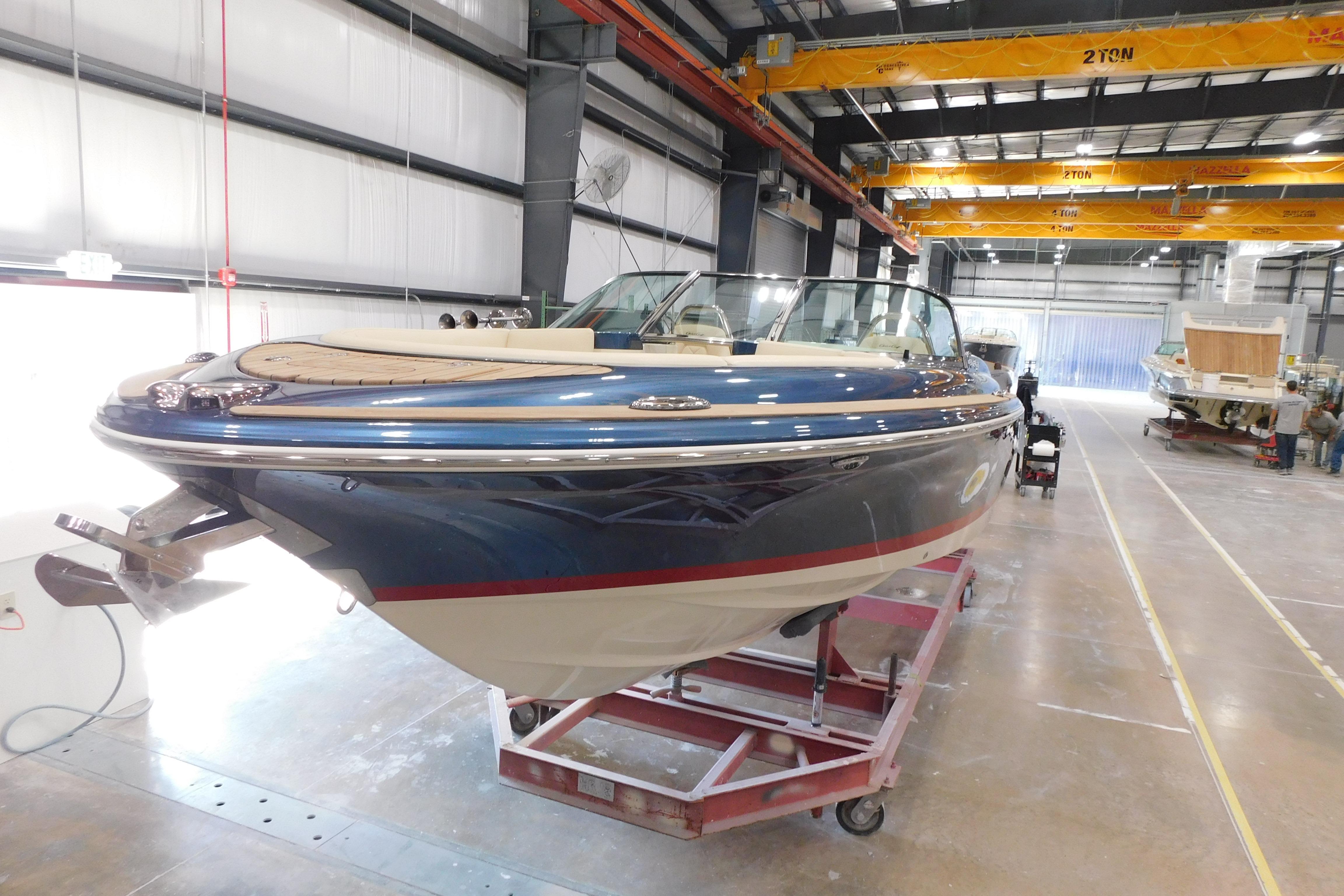 2025 Chris-Craft Launch 27 boat in a manufacturing facility, showcasing sleek design and craftsmanship.