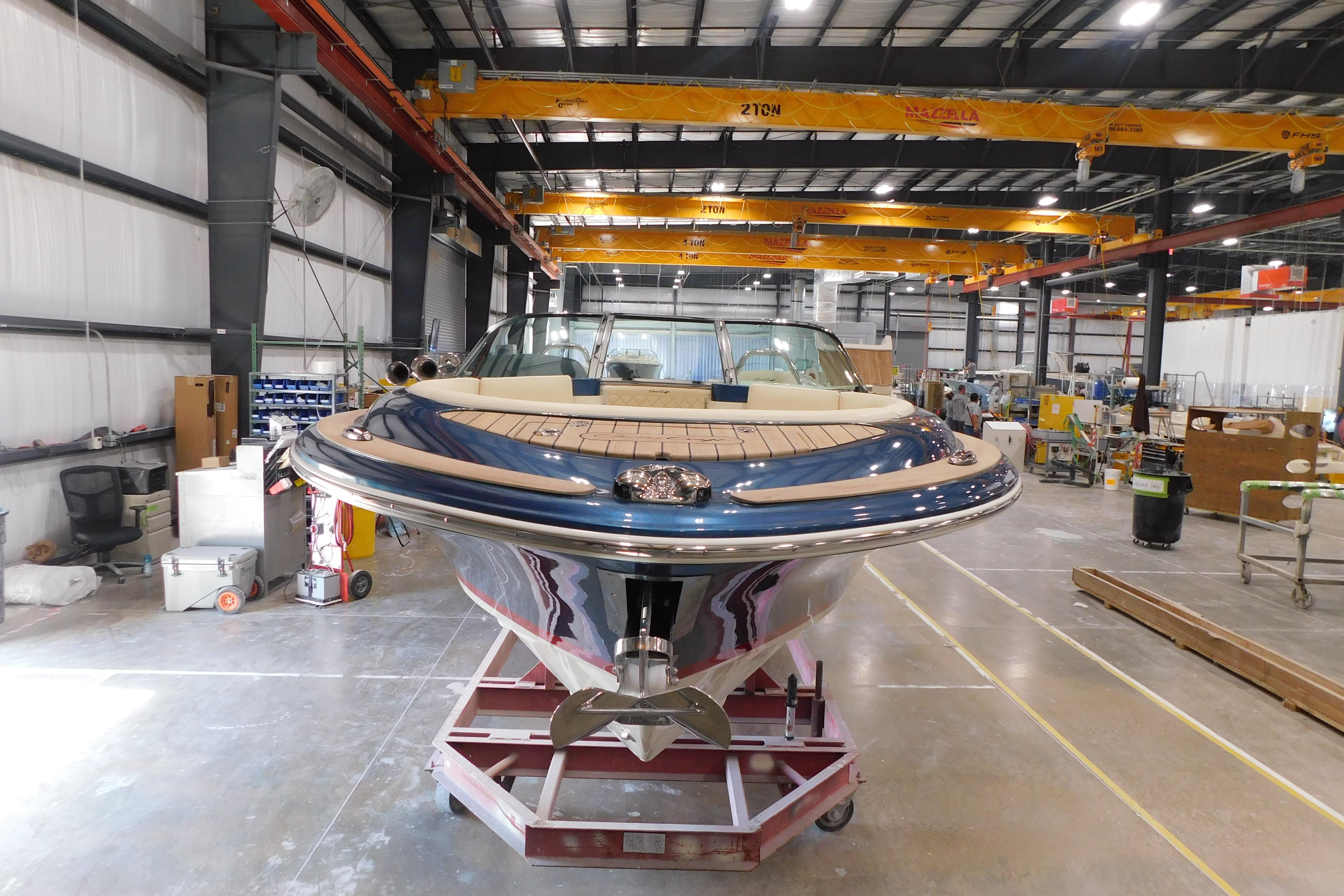 2025 Chris-Craft Launch 27 boat in a manufacturing facility.