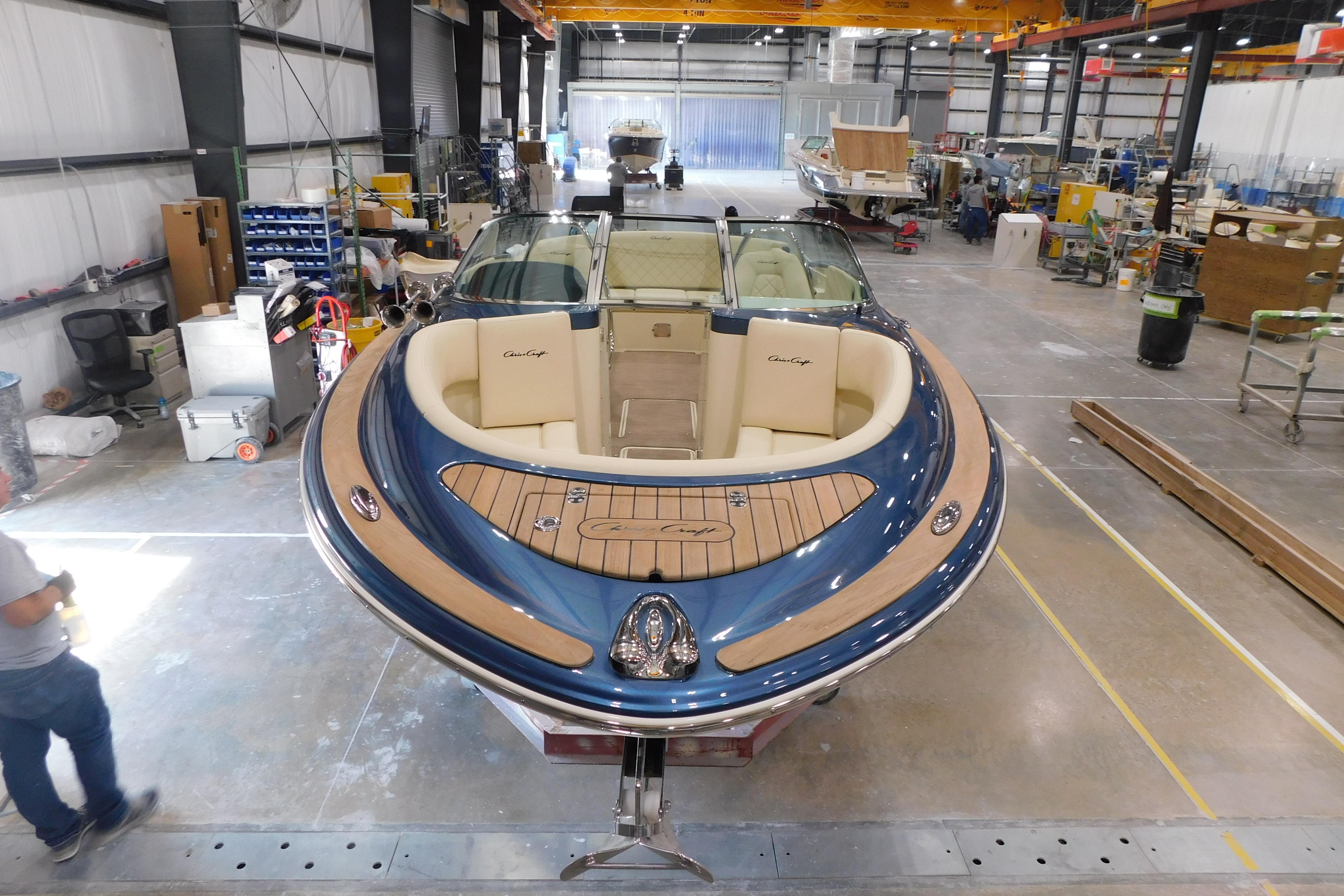 2025 Chris-Craft Launch 27 boat in a workshop, showcasing elegant design and craftsmanship.