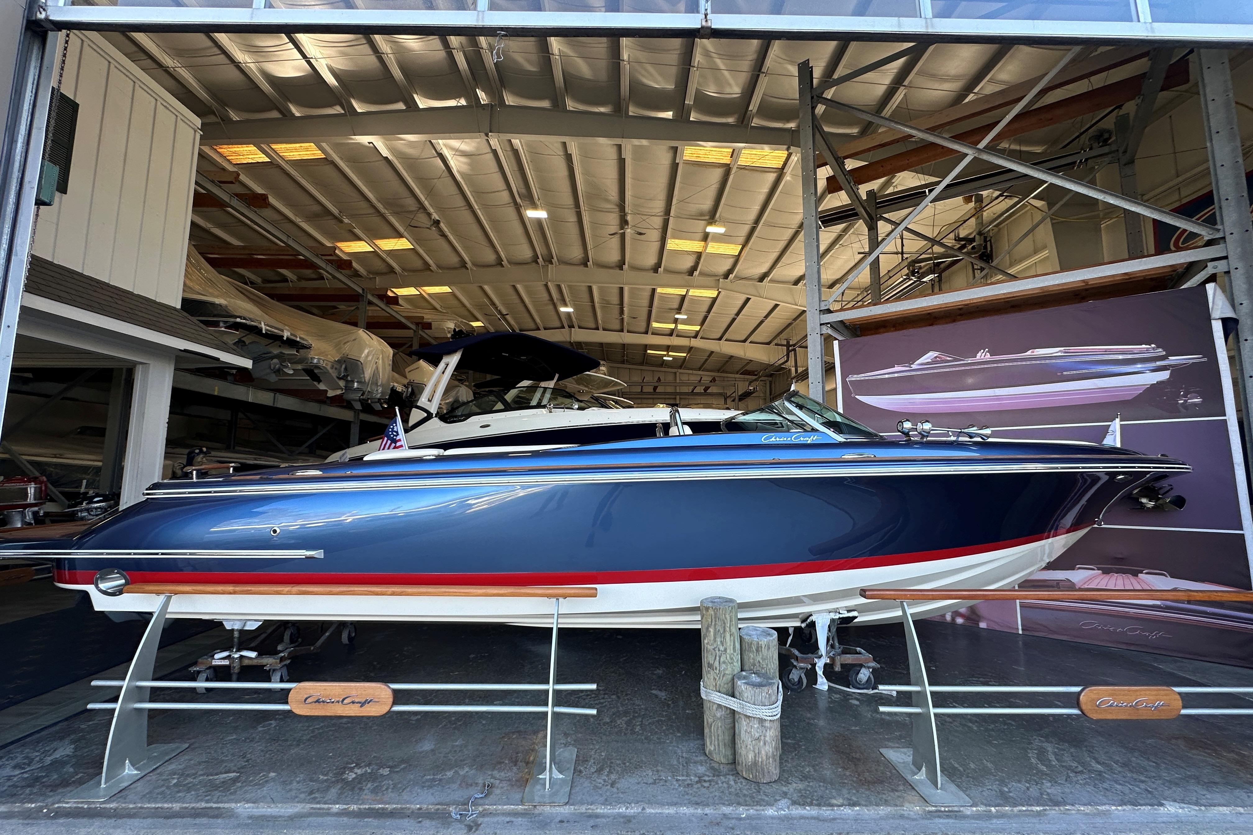 2025 Chris-Craft Launch 27 boat in showroom, blue hull, elegant design.