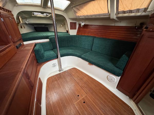 Interior of 1994 Hunter 29.5 sailboat with green seating and wood accents.