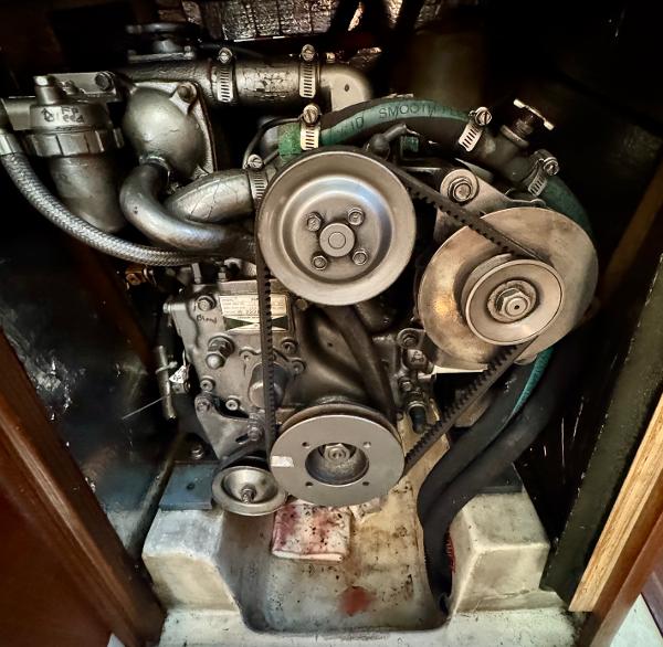 Engine of a 1994 Hunter 29.5 sailboat, showcasing belts and pulleys.