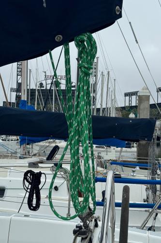 Sailboat docked at marina, featuring ropes and masts, Hunter 29.5, 1994 model.