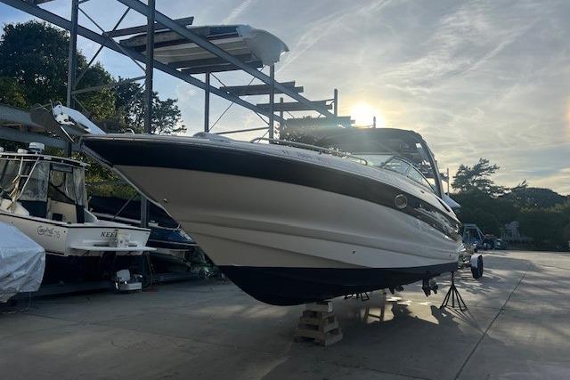 2007 Crownline 320 LS boat on dry dock at sunset, showcasing sleek design.