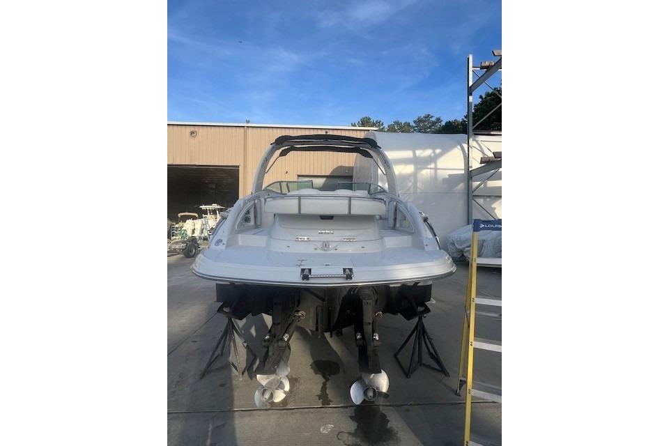 2007 Crownline 320 LS boat, rear view, docked outdoors.