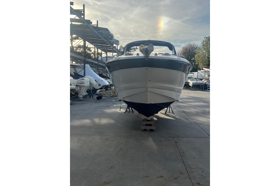 2007 Crownline 320 LS boat on dry dock, front view, with a rainbow in the sky.