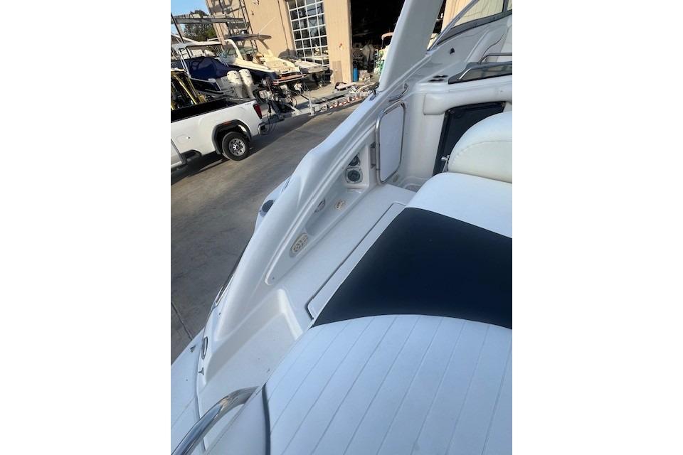 2007 Crownline 320 LS boat interior with white seating and docked boats in background.