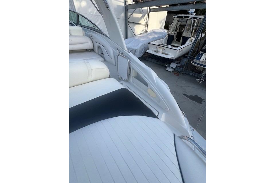 2007 Crownline 320 LS boat interior with white seating, docked near other boats.