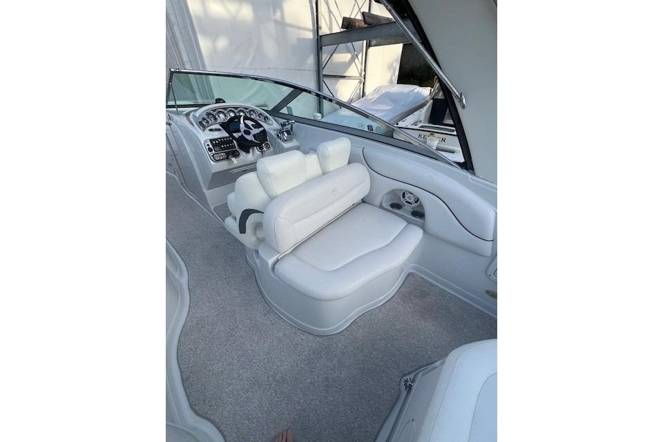 2007 Crownline 320 LS boat interior with white seating and modern dashboard.