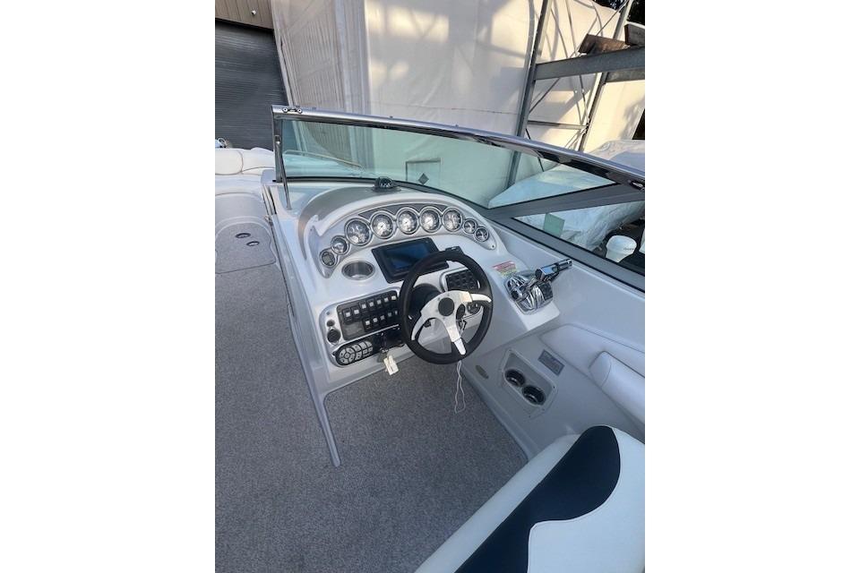 2007 Crownline 320 LS boat dashboard with steering wheel and control panel.