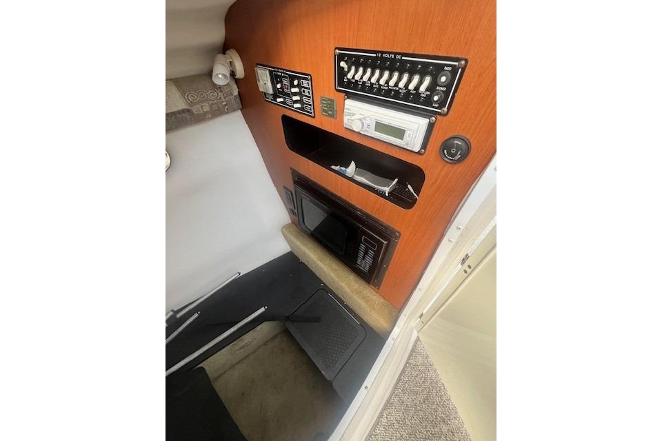 2007 Crownline 320 LS cabin interior with control panel and microwave.