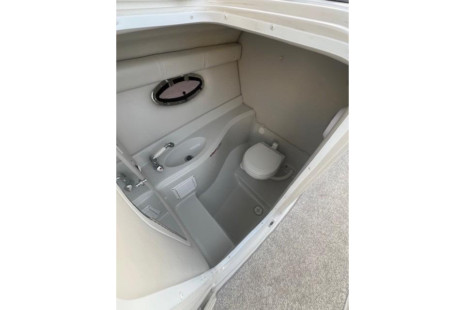 2007 Crownline 320 LS boat interior bathroom with sink and toilet.