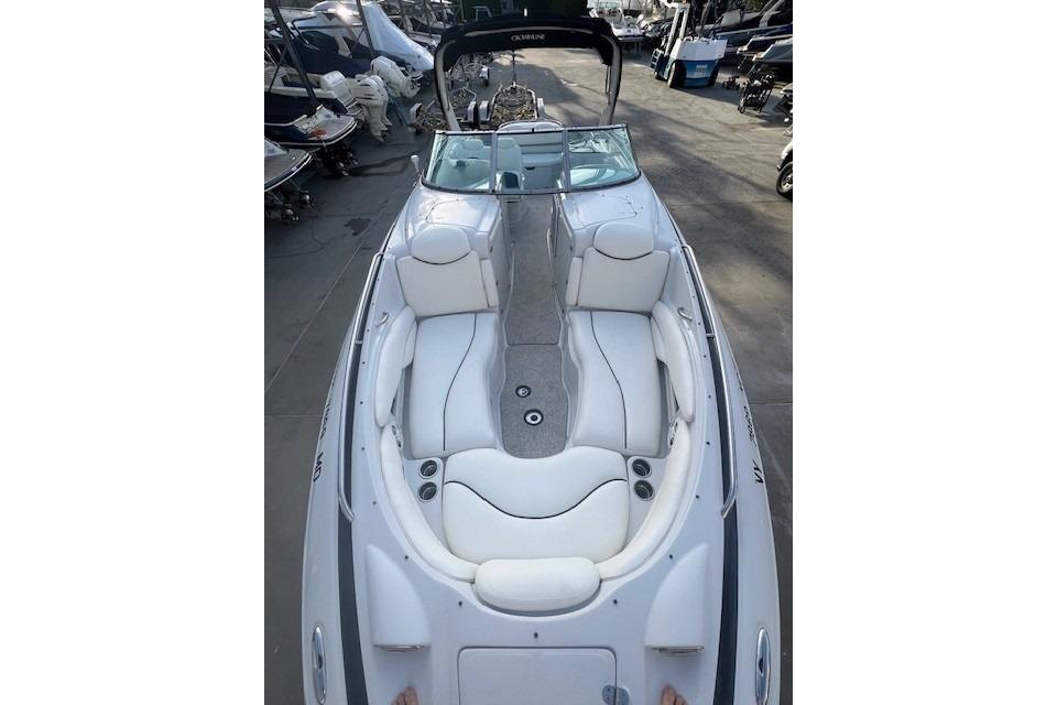 2007 Crownline 320 LS boat with white seating and sleek design in a marina.