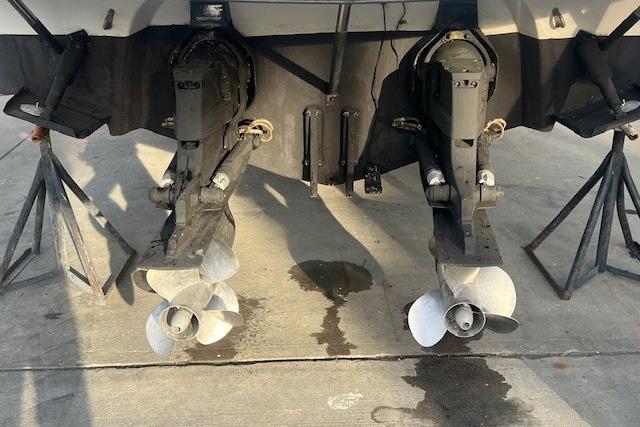 2007 Crownline 320 LS boat propellers on dry dock, showing dual outboard motors.