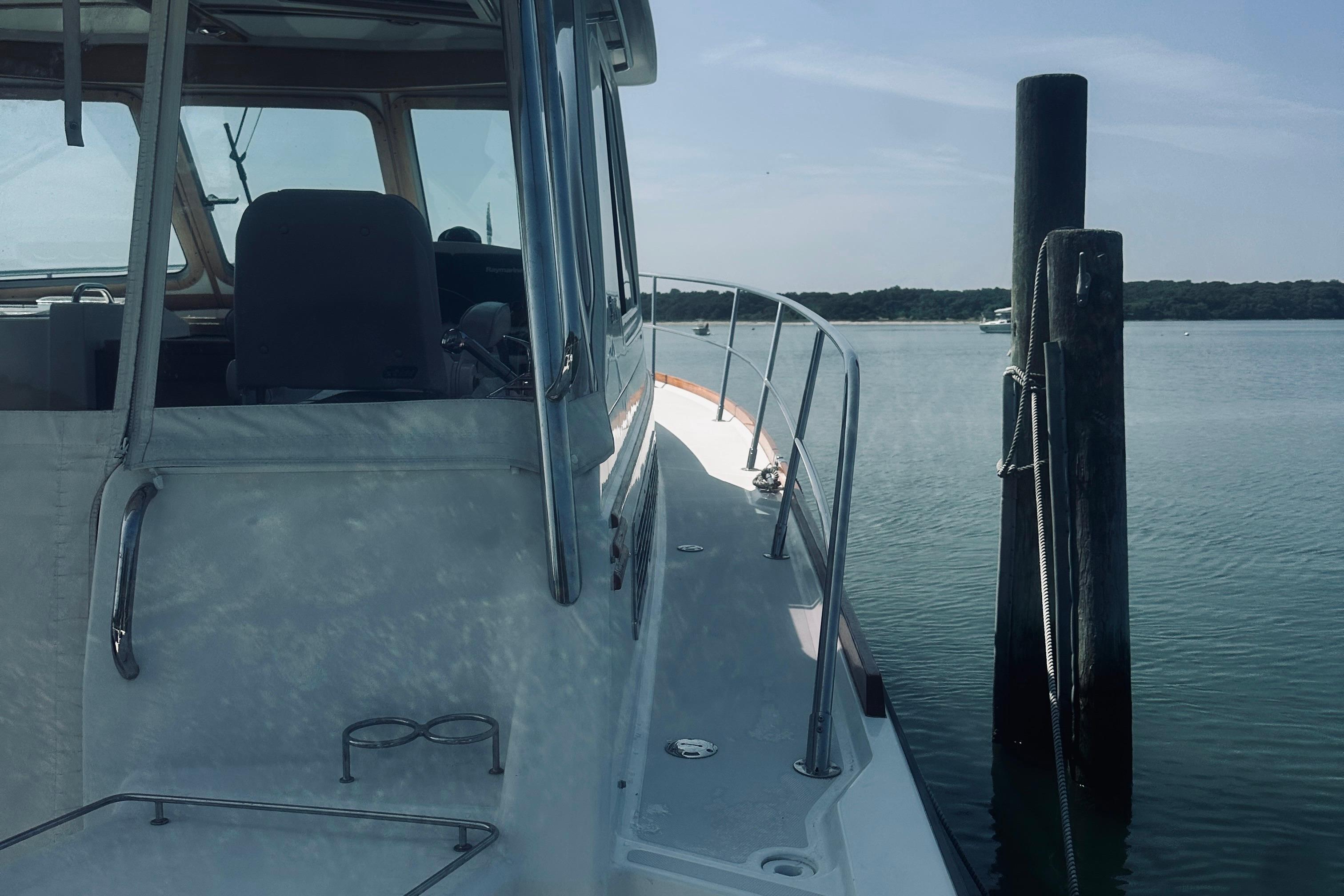 2007 Sabreline 34 Express yacht docked by calm waters.