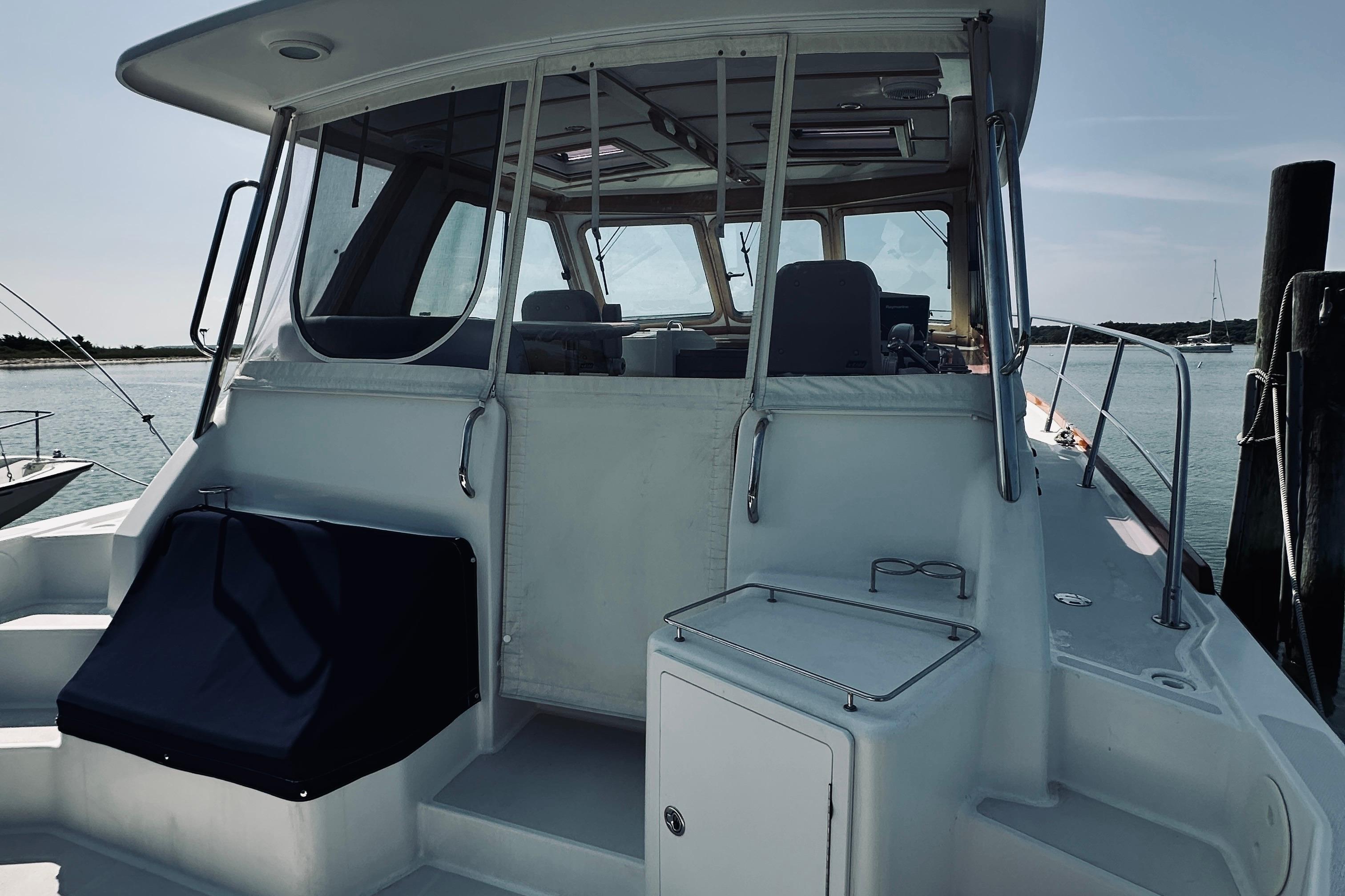 2007 Sabreline 34 Express boat docked, showcasing rear deck and cabin entrance.