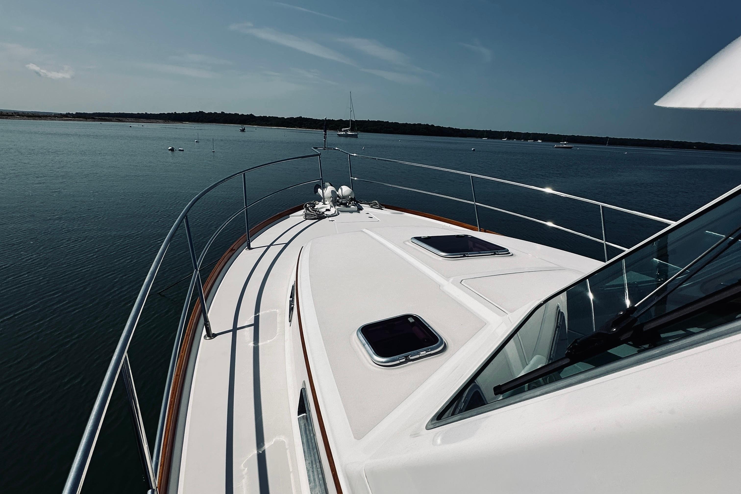 2007 Sabreline 34 Express yacht cruising on calm waters under clear skies.