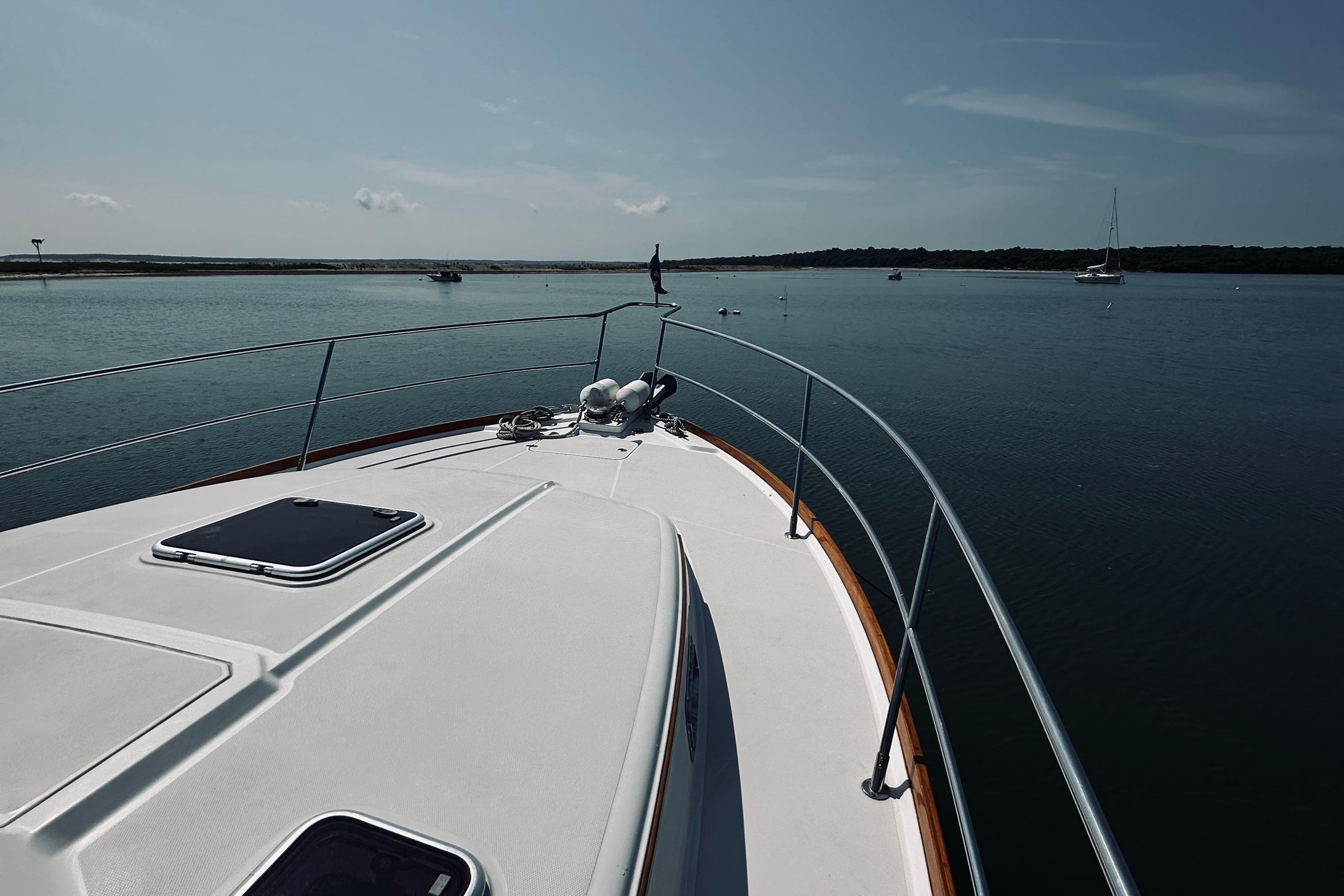 2007 Sabreline 34 Express yacht on calm waters, showcasing sleek deck design.