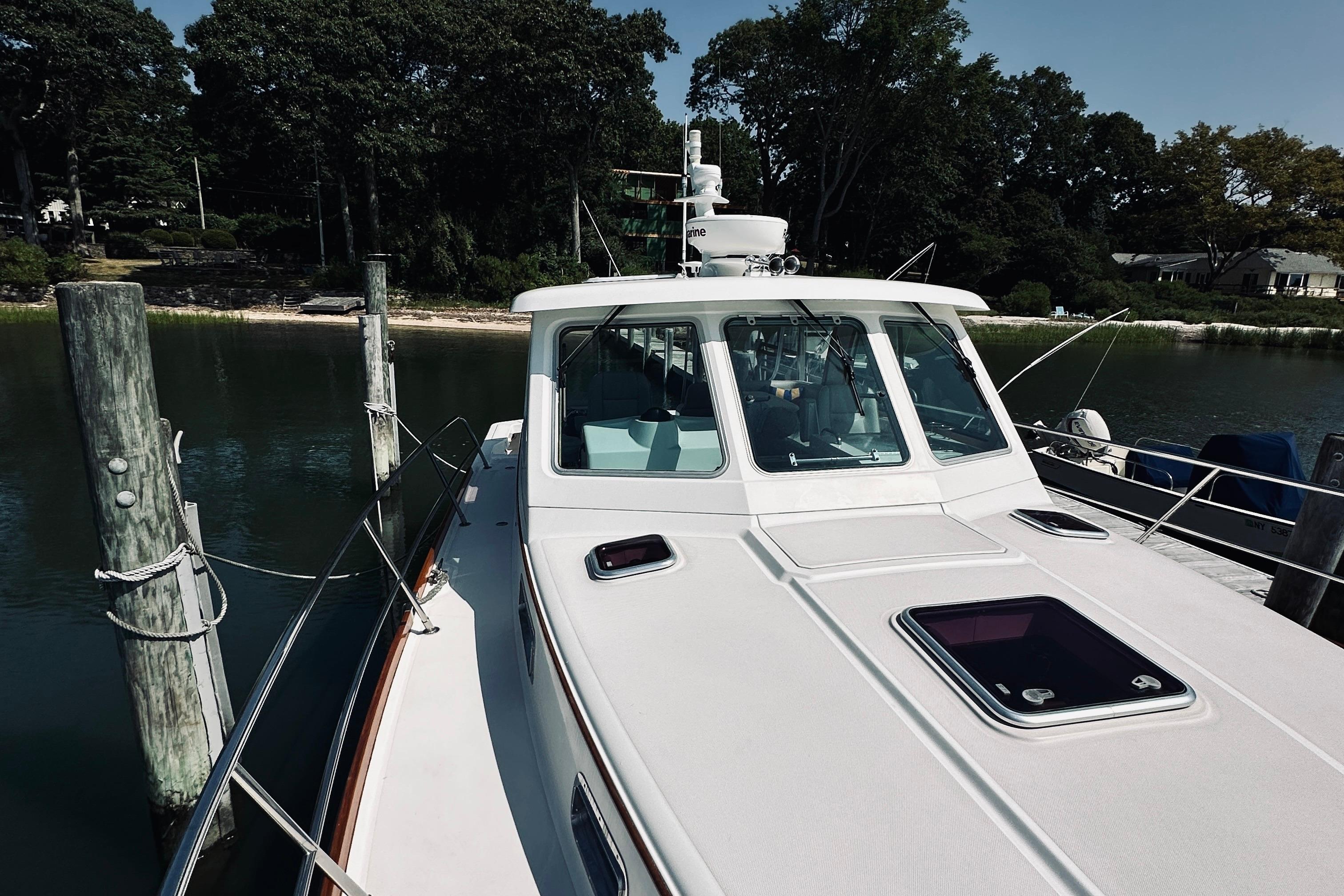2007 Sabreline 34 Express boat docked by a serene waterfront.
