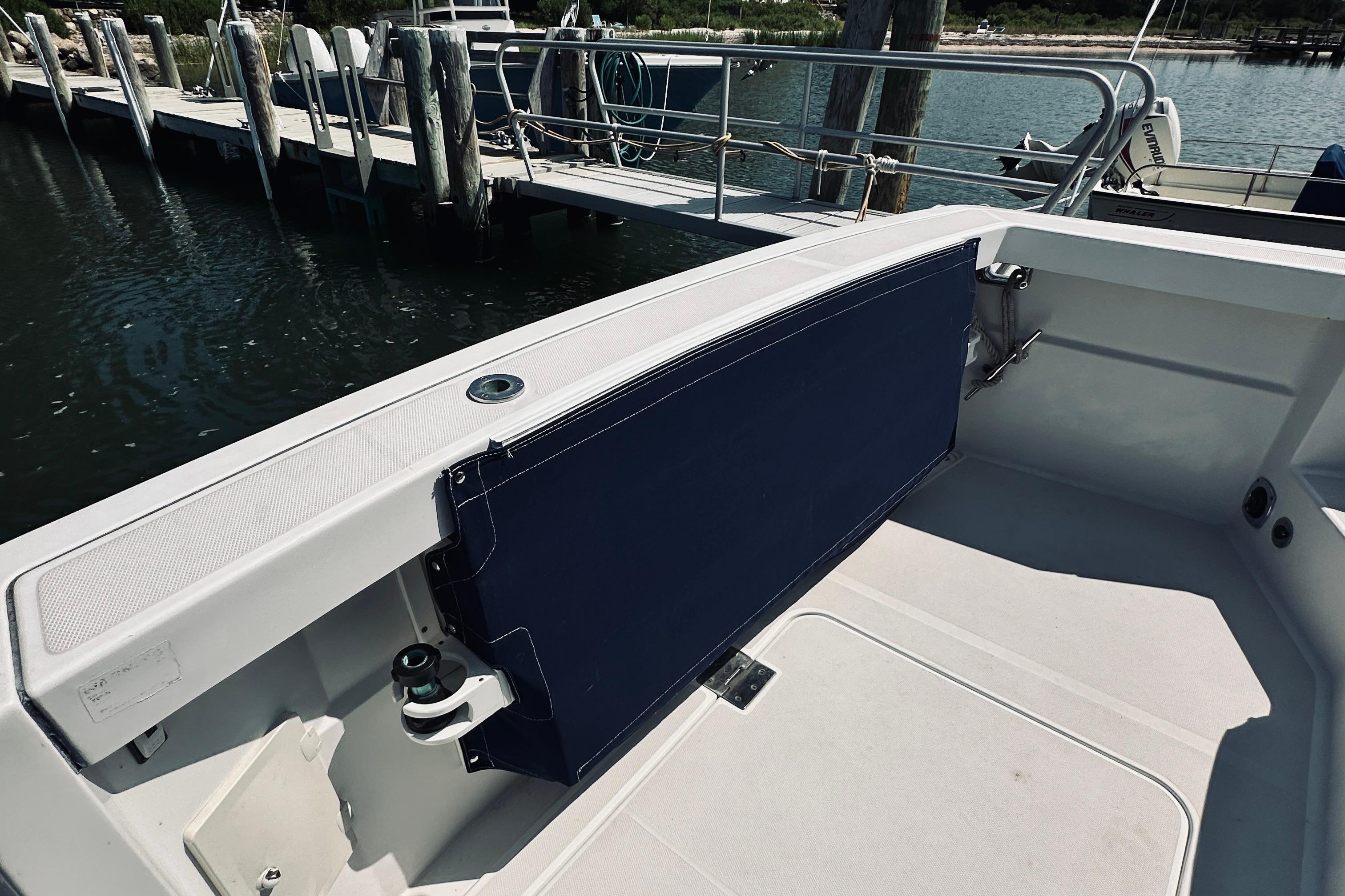 2007 Sabreline 34 Express boat interior with blue seating and dock view.