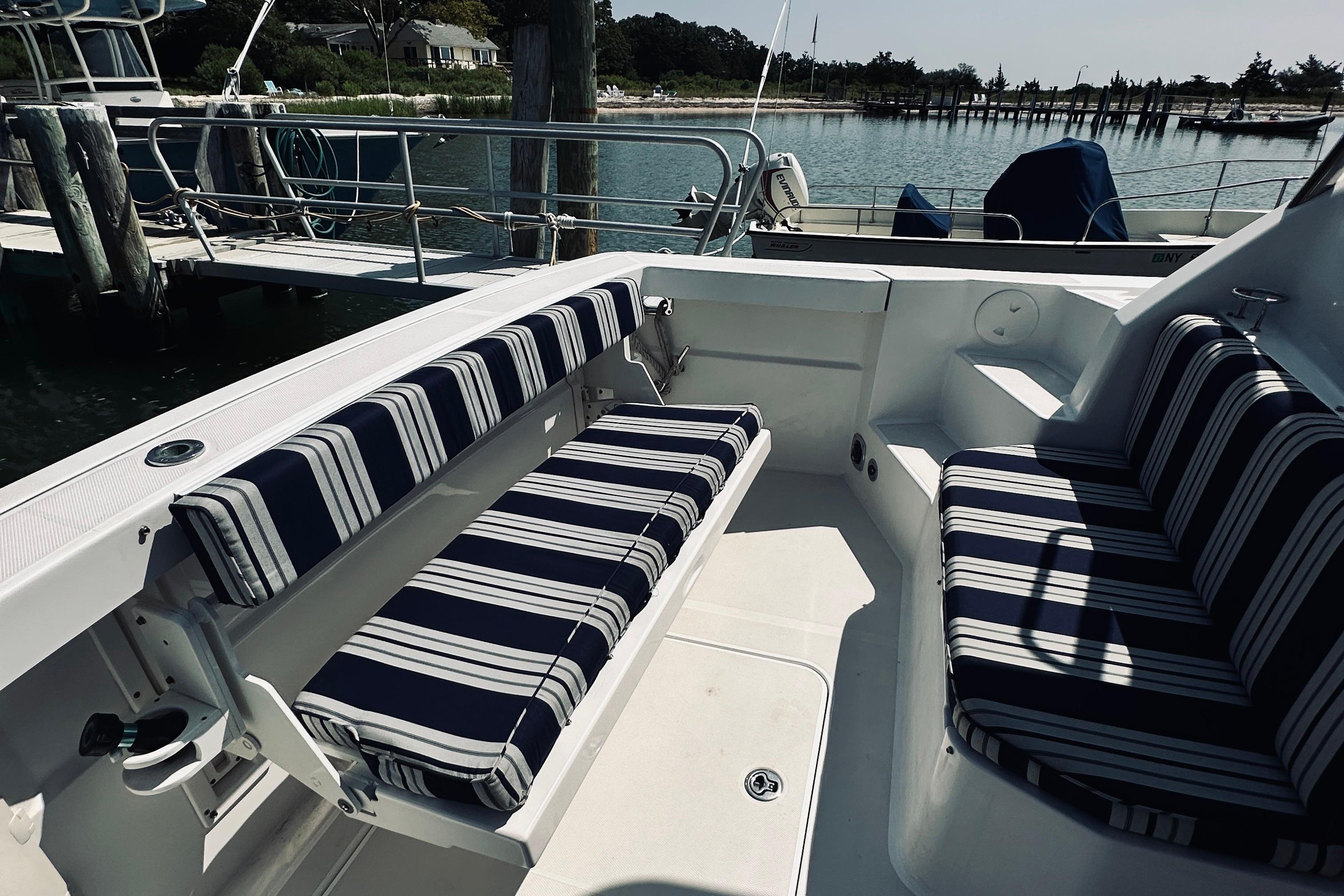 2007 Sabreline 34 Express boat interior with striped seating at a marina.