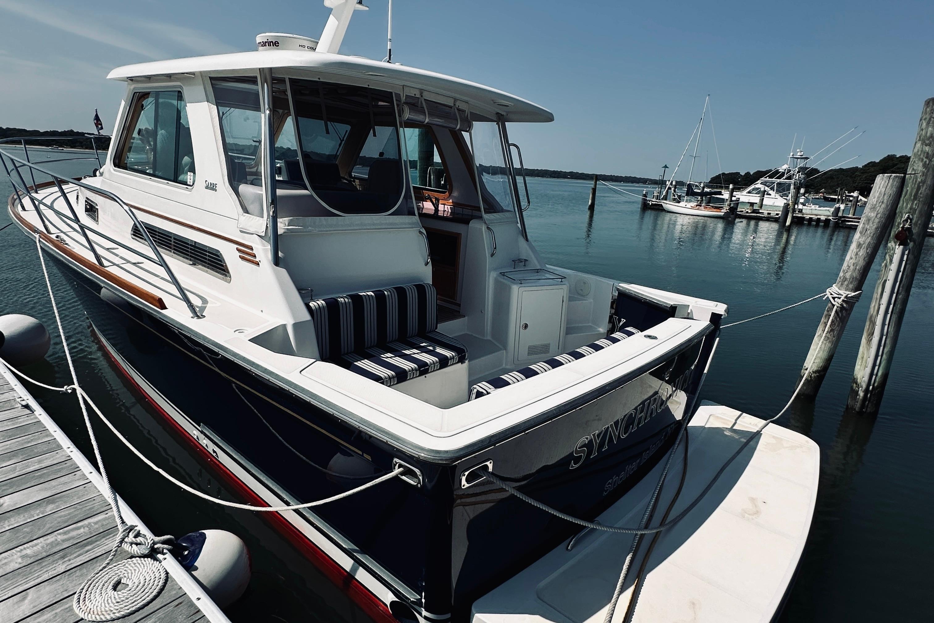 2007 Sabreline 34 Express boat docked at marina, featuring sleek design and spacious deck.