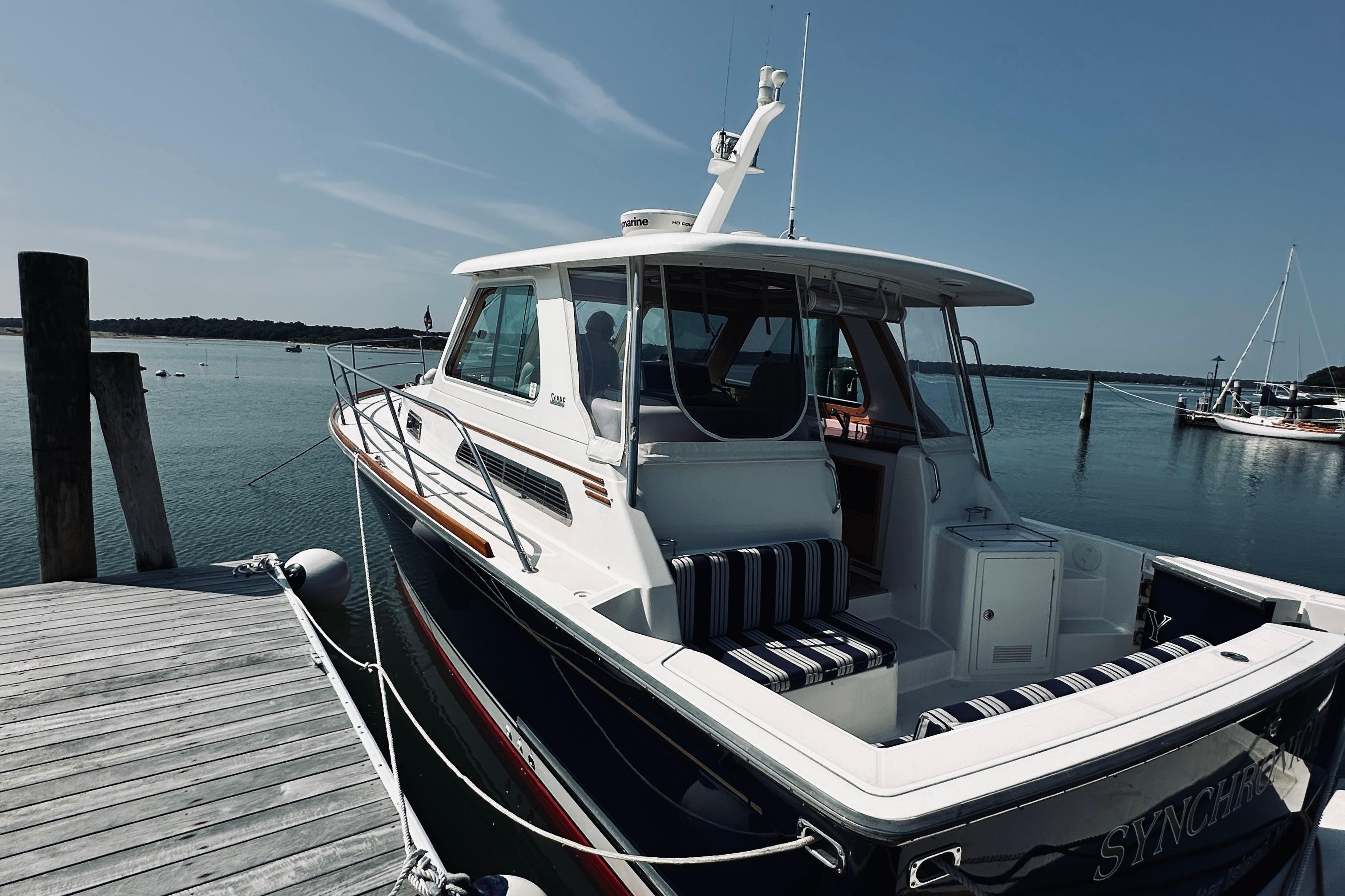 2007 Sabreline 34 Express boat docked at a serene marina.