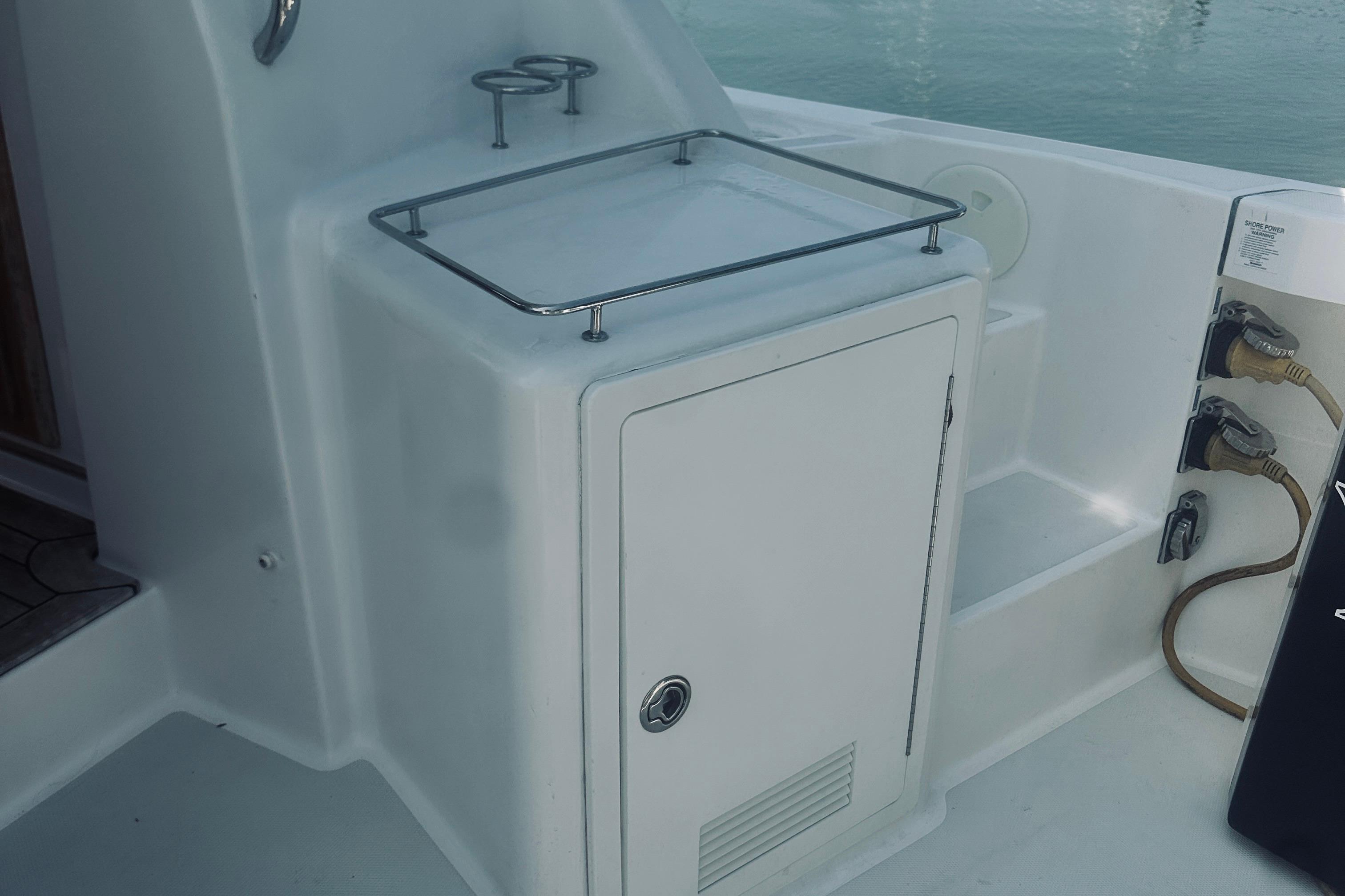 2007 Sabreline 34 Express boat deck with storage compartment and power connections.