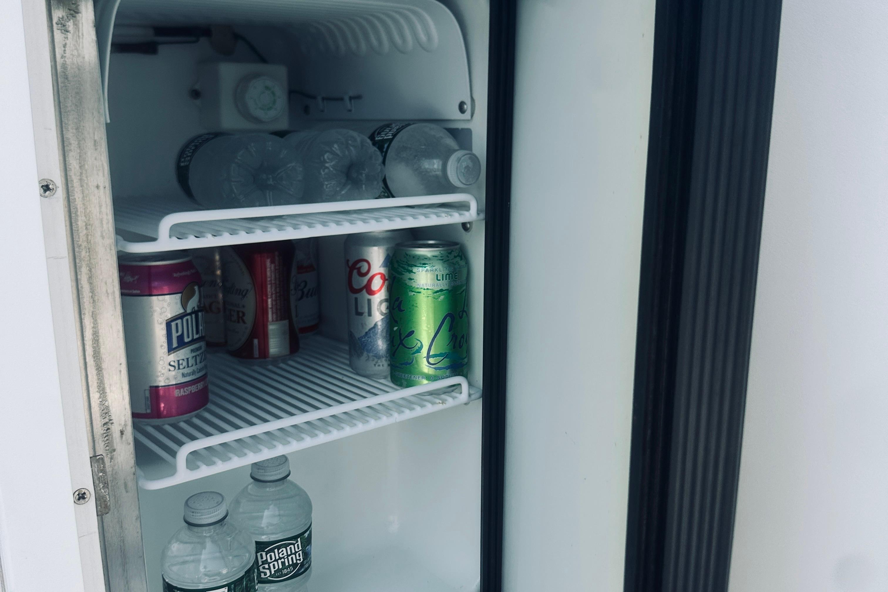 Mini fridge stocked with drinks on a 2007 Sabreline 34 Express boat.