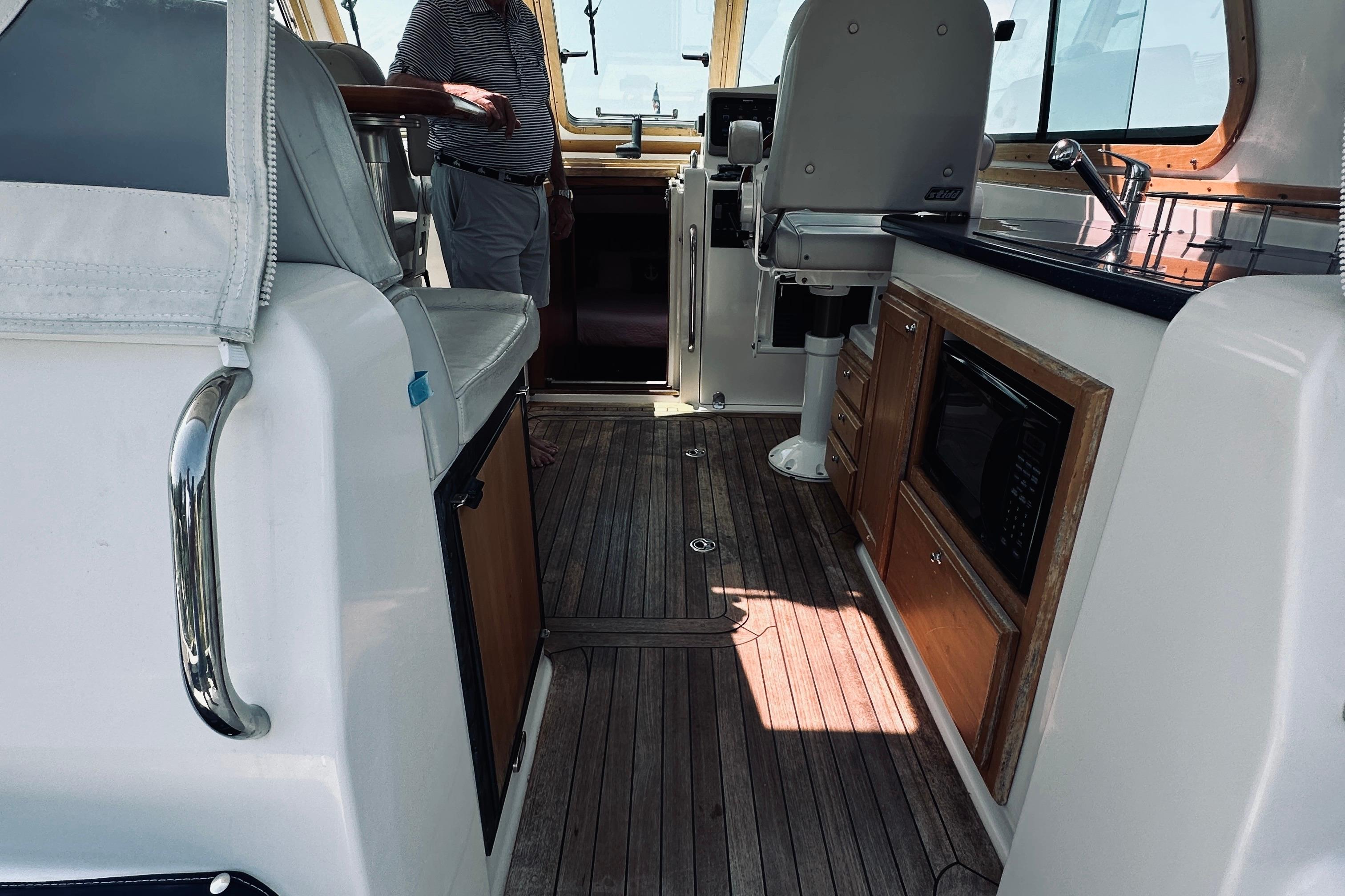 Interior of 2007 Sabreline 34 Express yacht with wood flooring and kitchenette.