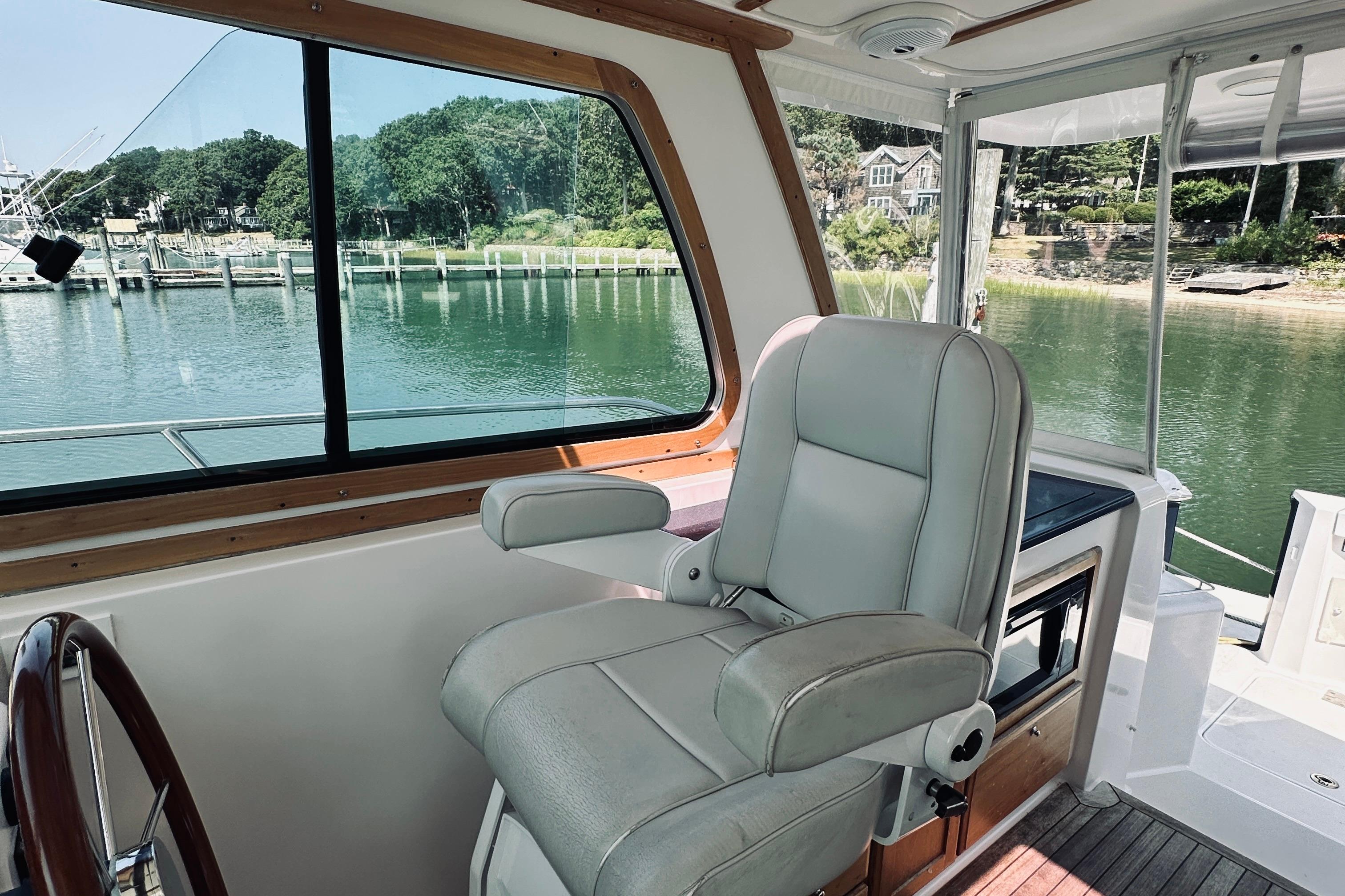Interior of 2007 Sabreline 34 Express boat with helm seat and scenic water view.