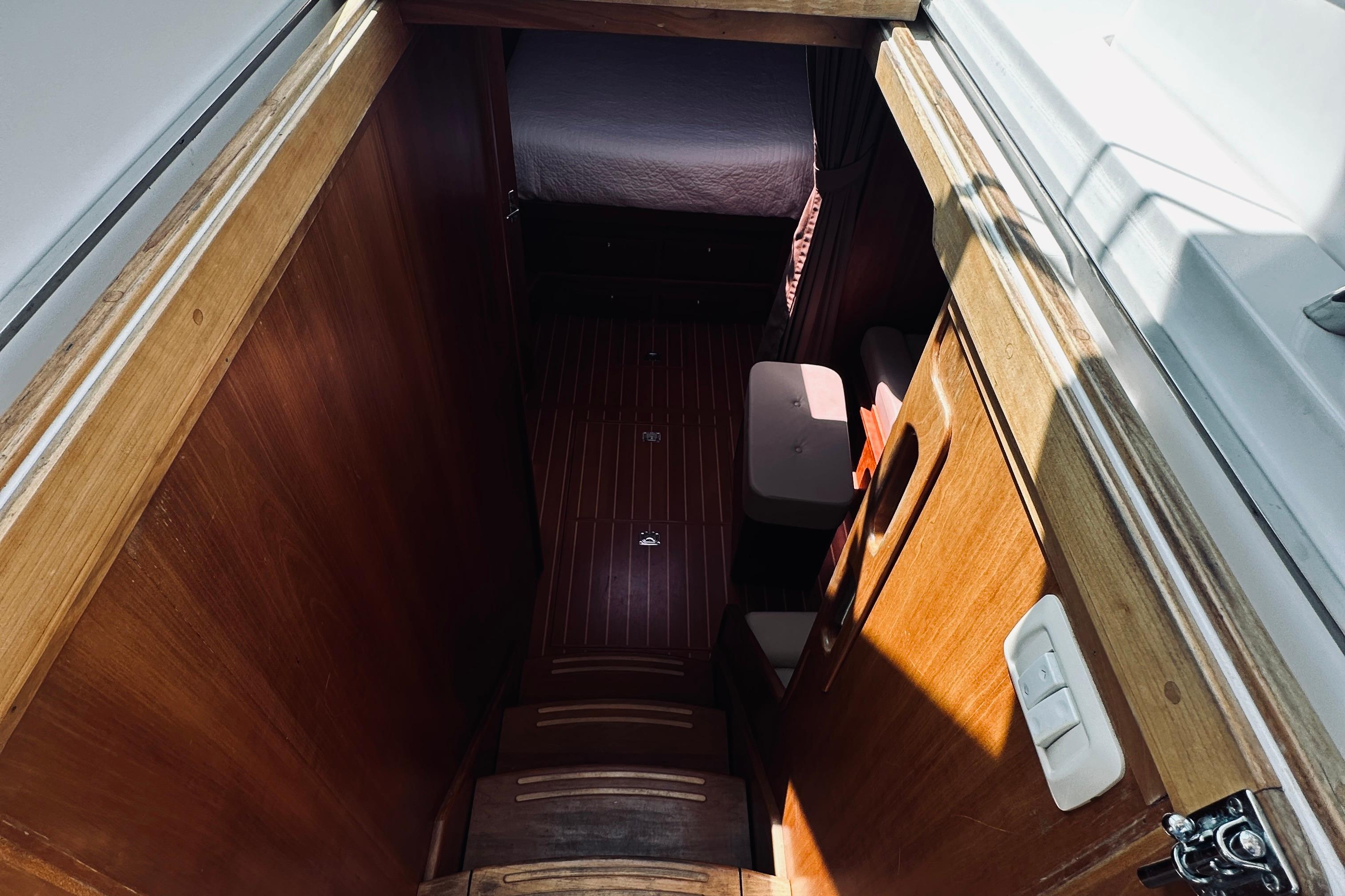 Interior view of 2007 Sabreline 34 Express boat, featuring wooden stairs and cabin entrance.