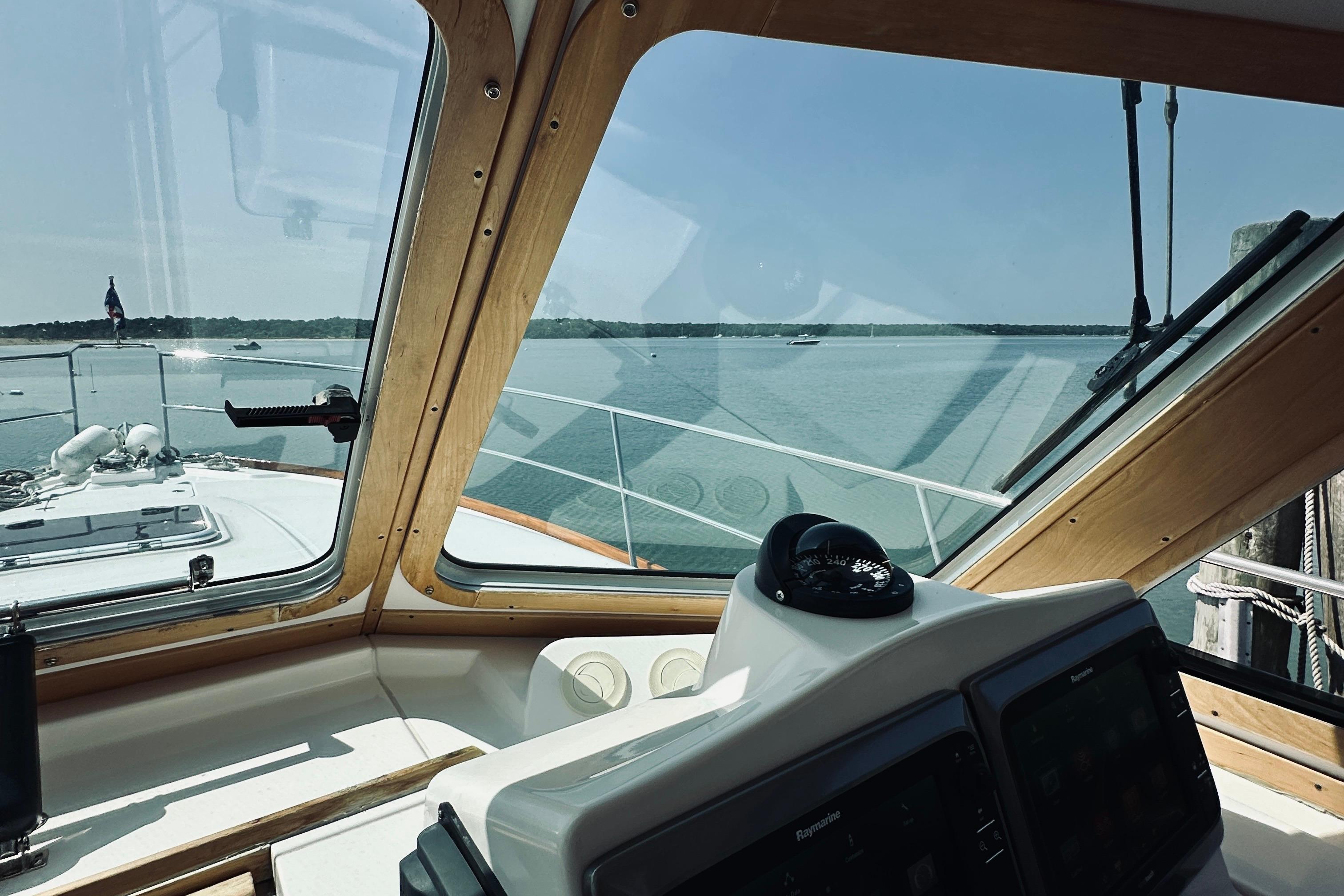 2007 Sabreline 34 Express helm view with scenic water backdrop.