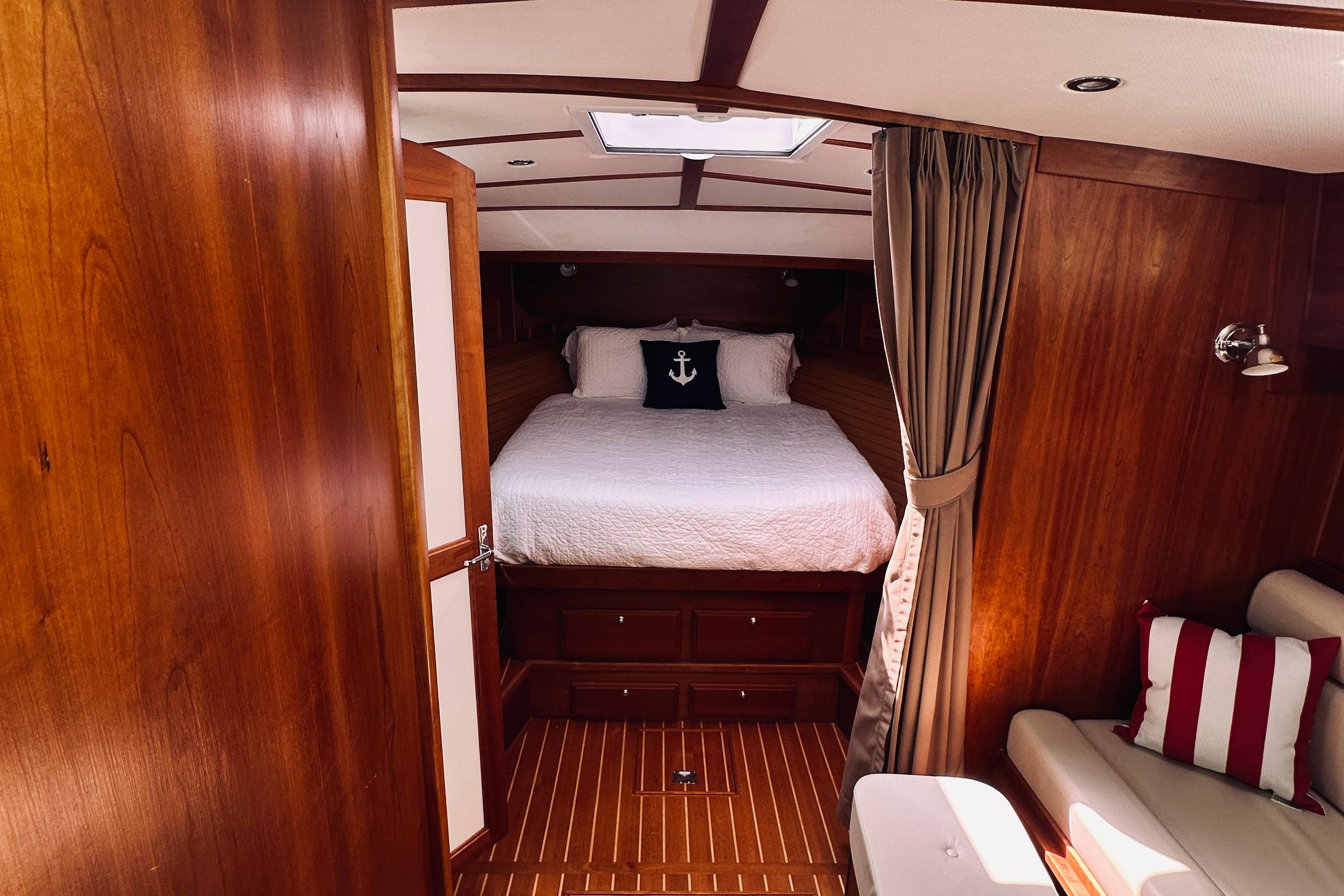 Luxurious 2007 Sabreline 34 Express cabin interior with wood finish and cozy bedding.