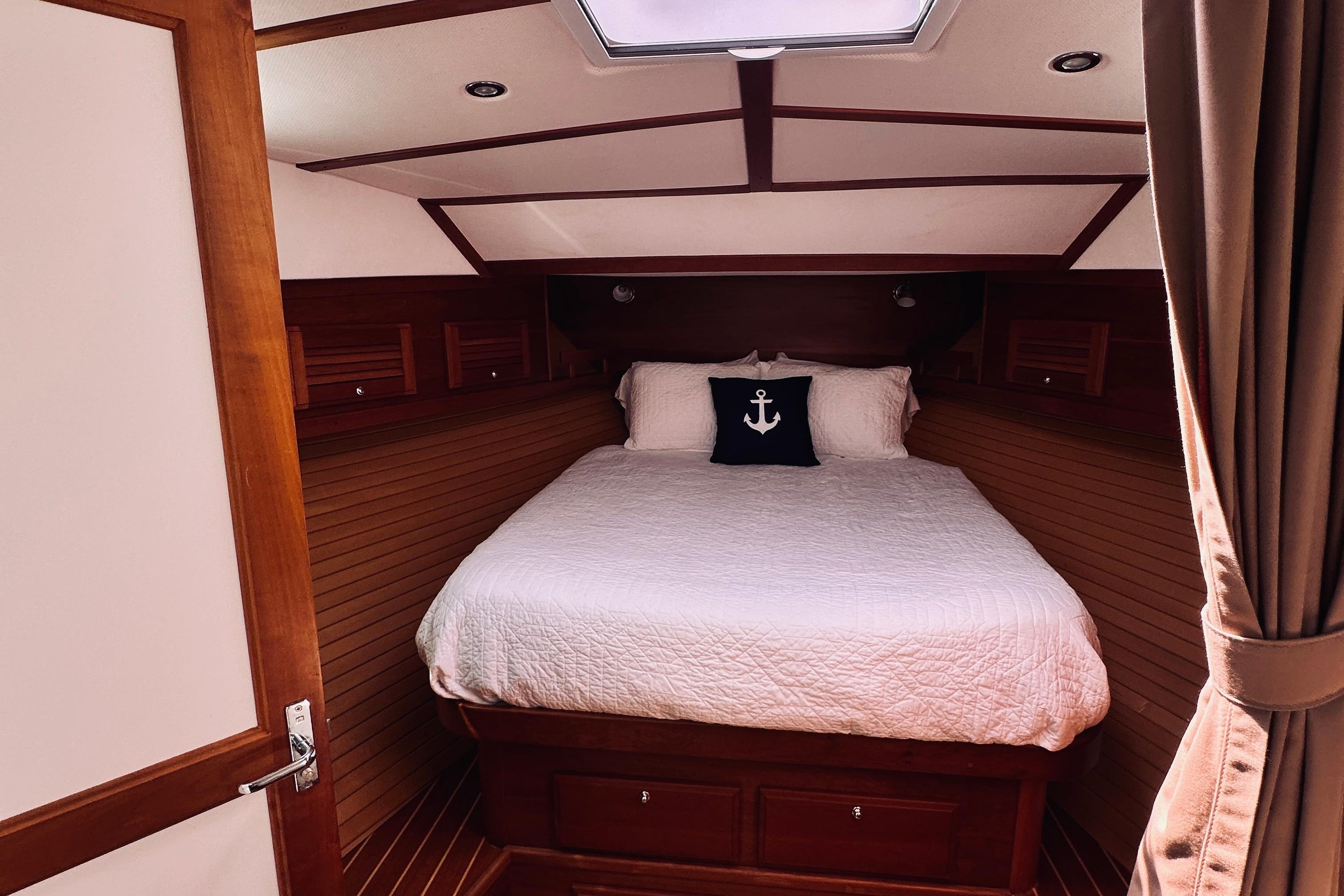Cozy cabin interior of 2007 Sabreline 34 Express with nautical-themed bedding.