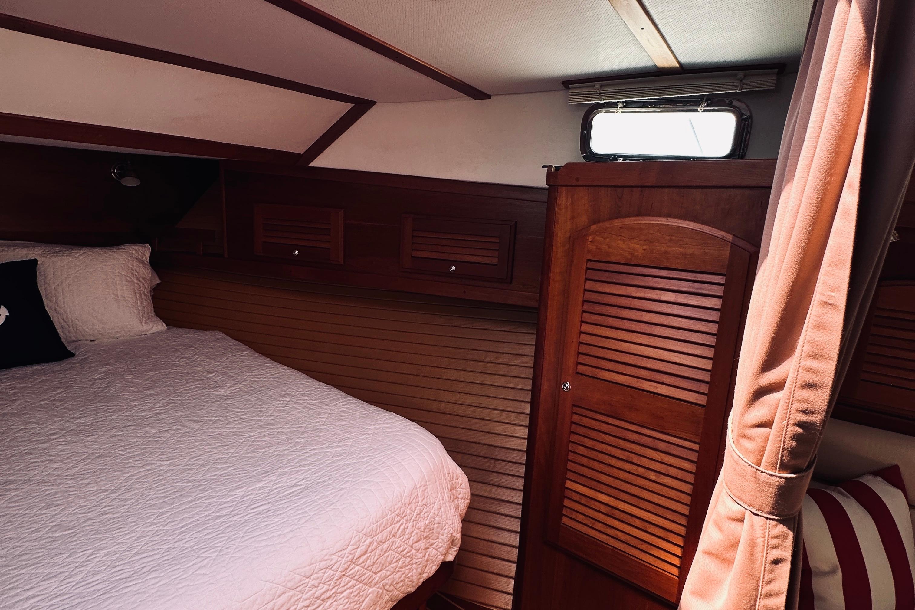 Cozy cabin interior of 2007 Sabreline 34 Express with wood paneling and bed.