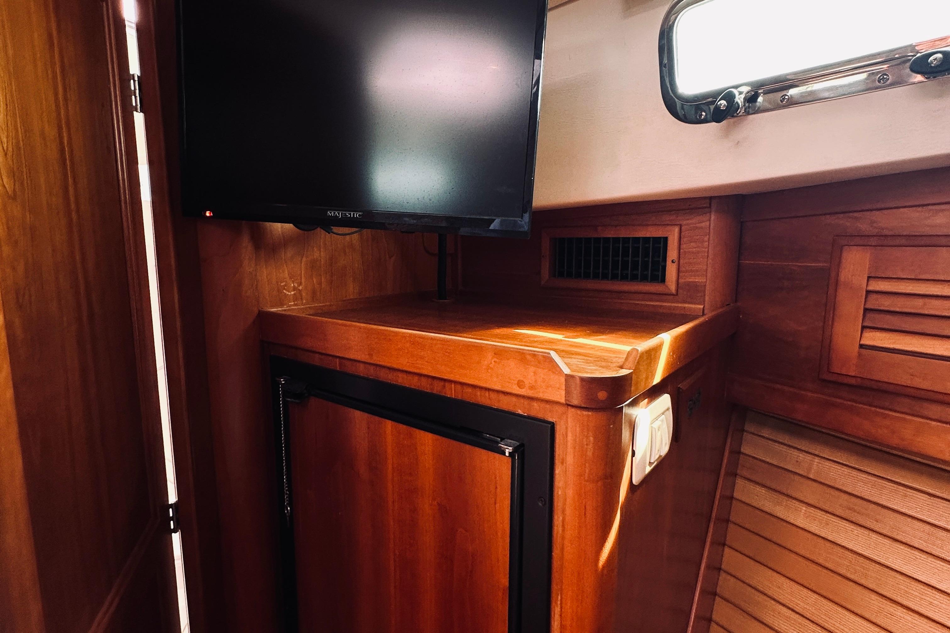 Interior of 2007 Sabreline 34 Express with wooden cabinetry and mounted TV.