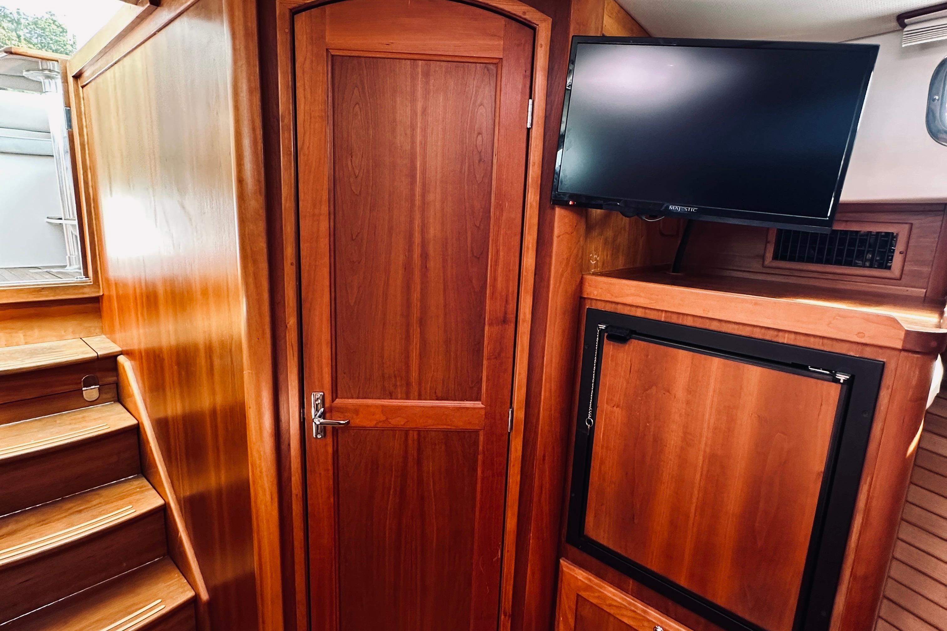 Interior of 2007 Sabreline 34 Express with wooden cabinetry and mounted TV.