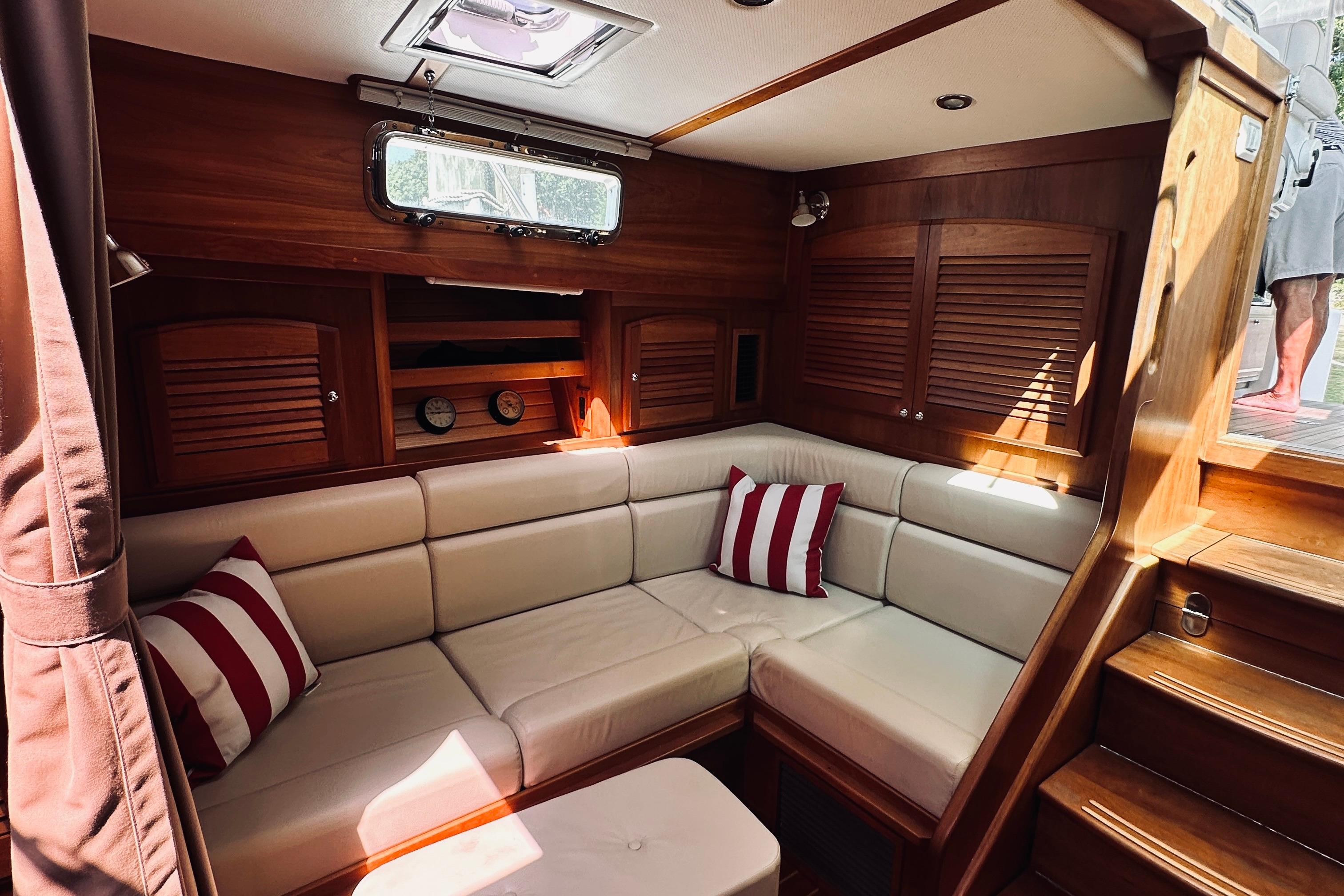 Interior of 2007 Sabreline 34 Express yacht with cozy seating and striped cushions.
