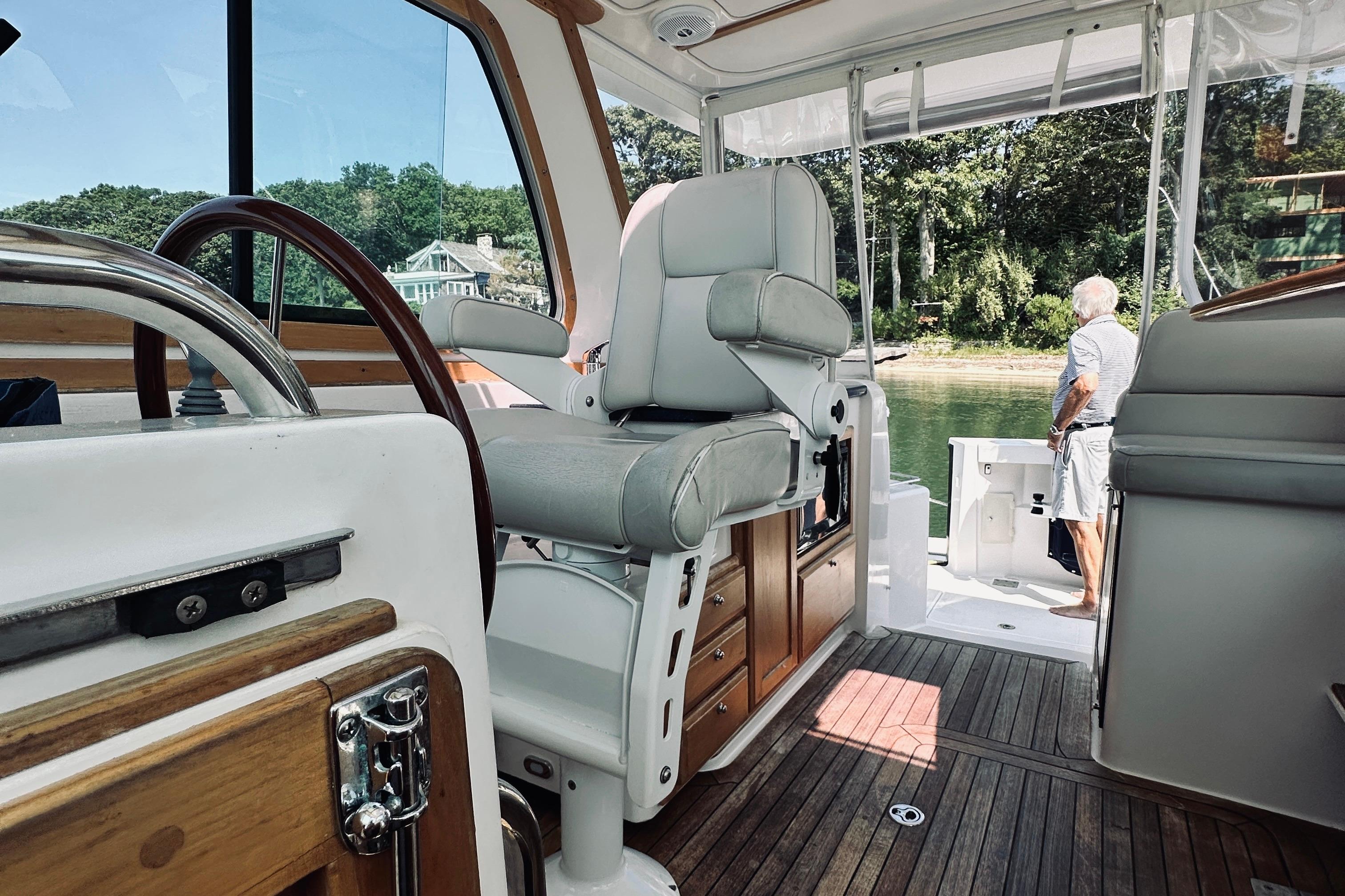 2007 Sabreline 34 Express boat interior with helm, seating, and view of water.