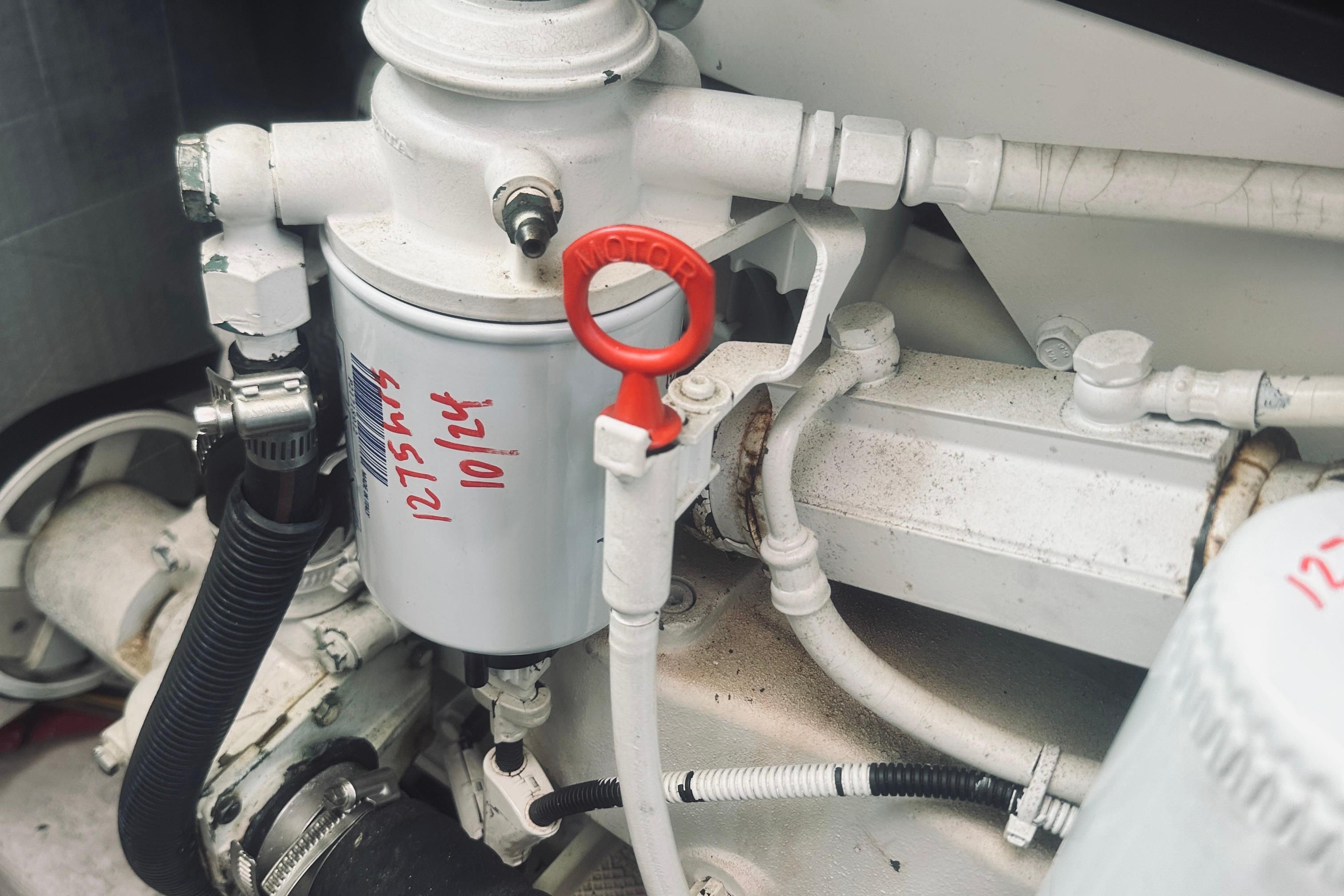 Engine components of a 2007 Sabreline 34 Express boat, featuring a filter and red dipstick.
