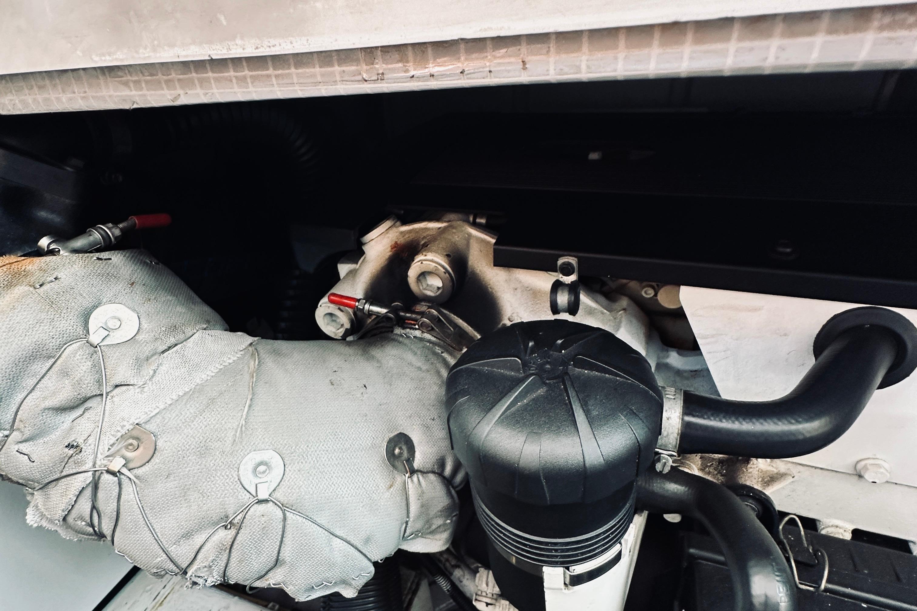 Engine compartment of a 2007 Sabreline 34 Express boat, showing insulated components and hoses.