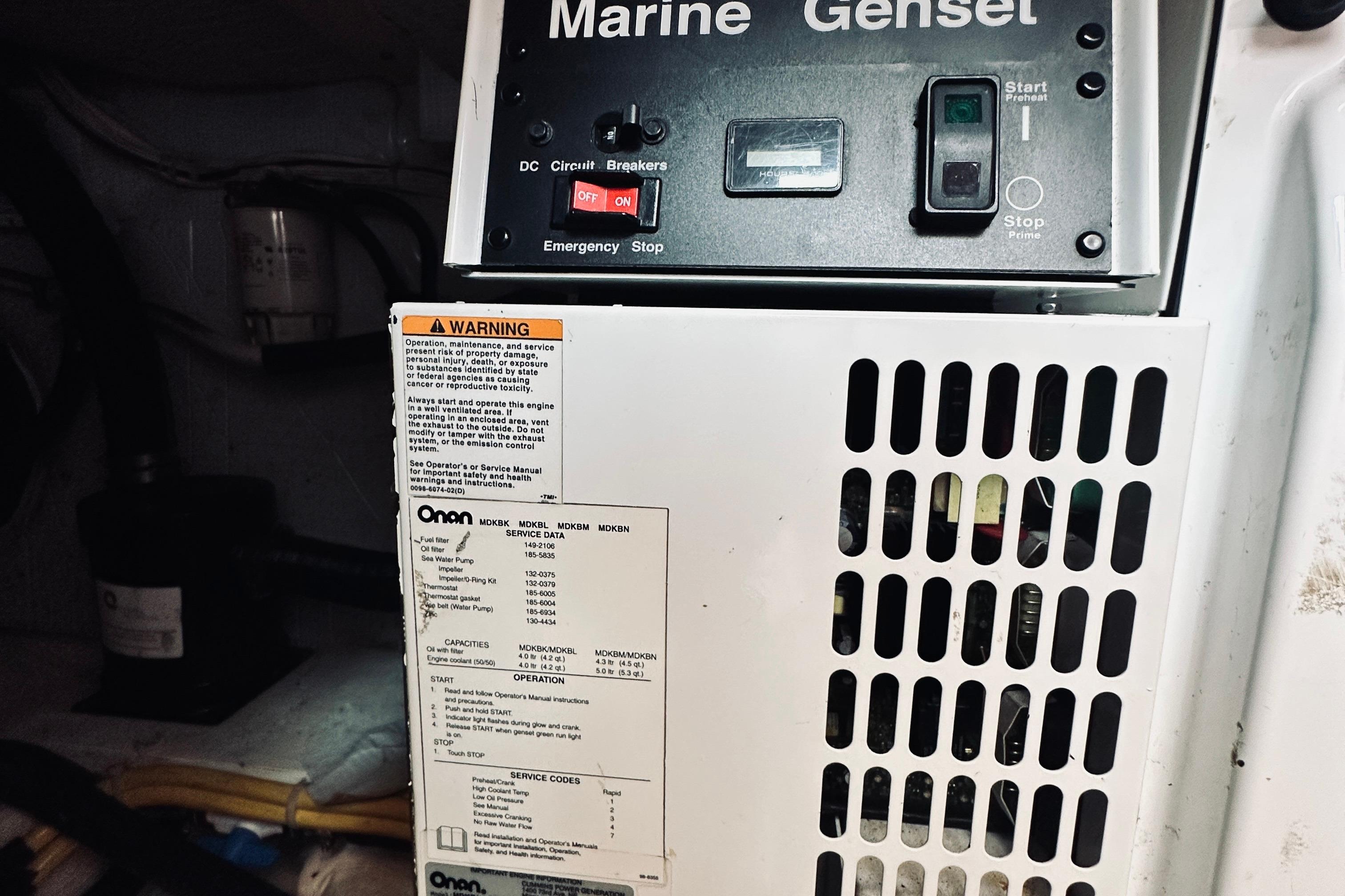 2007 Sabreline 34 Express marine generator control panel with warning label and specifications.