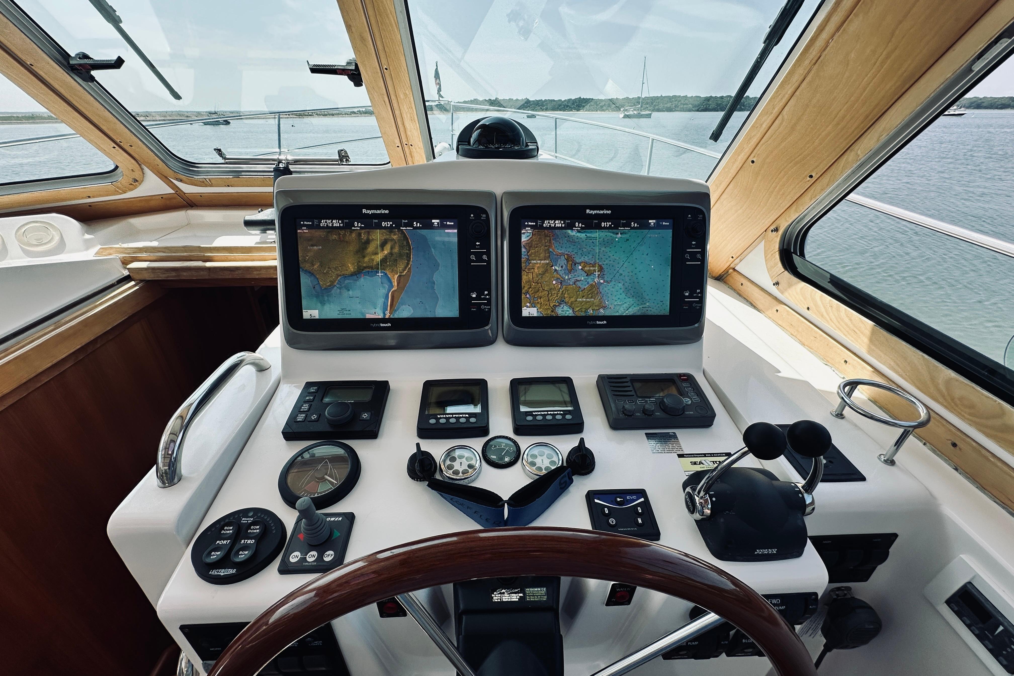 2007 Sabreline 34 Express helm with navigation screens and controls on a sunny day.