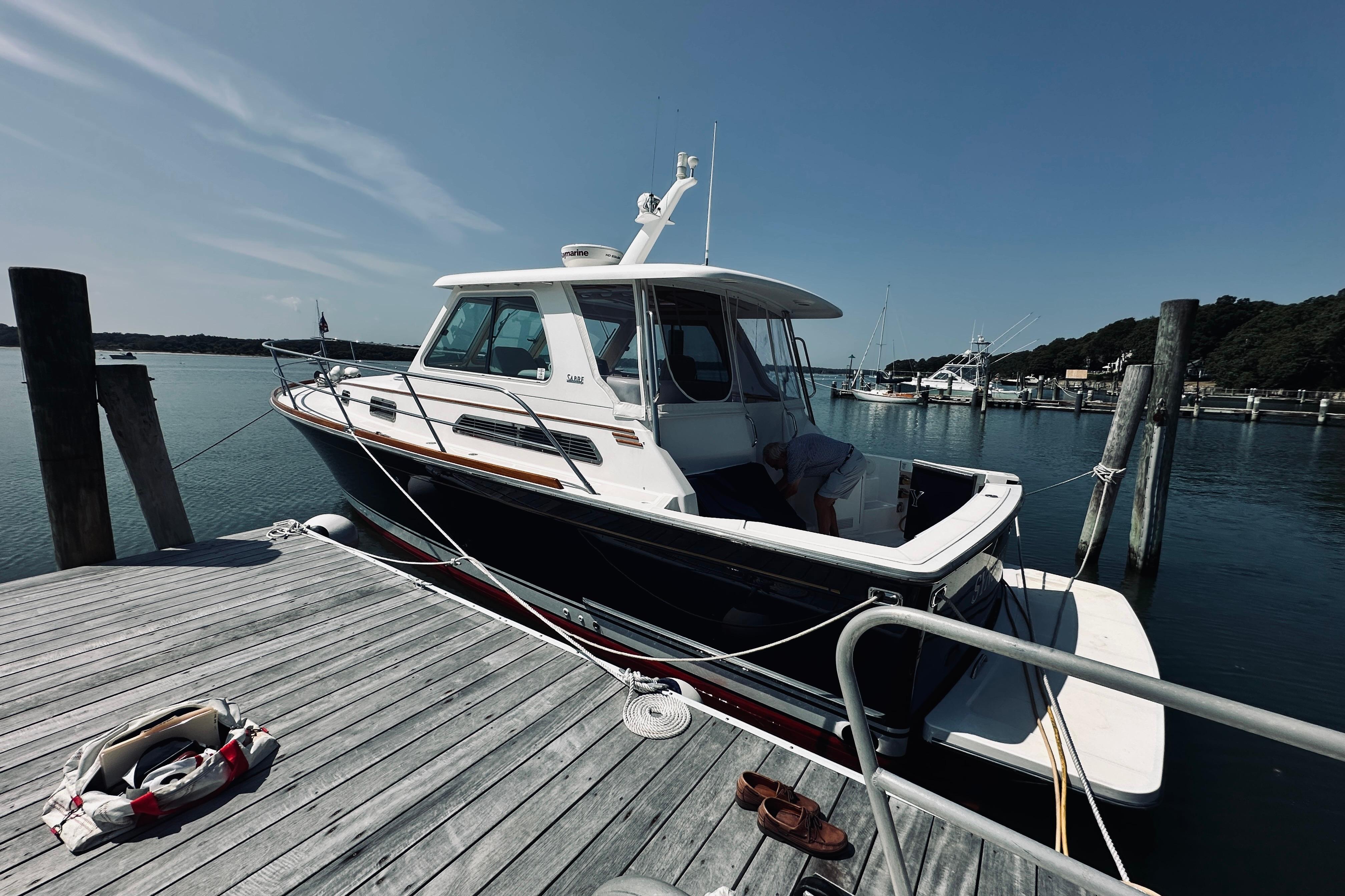 2007 Sabreline 34 Express boat docked at a marina on a sunny day.