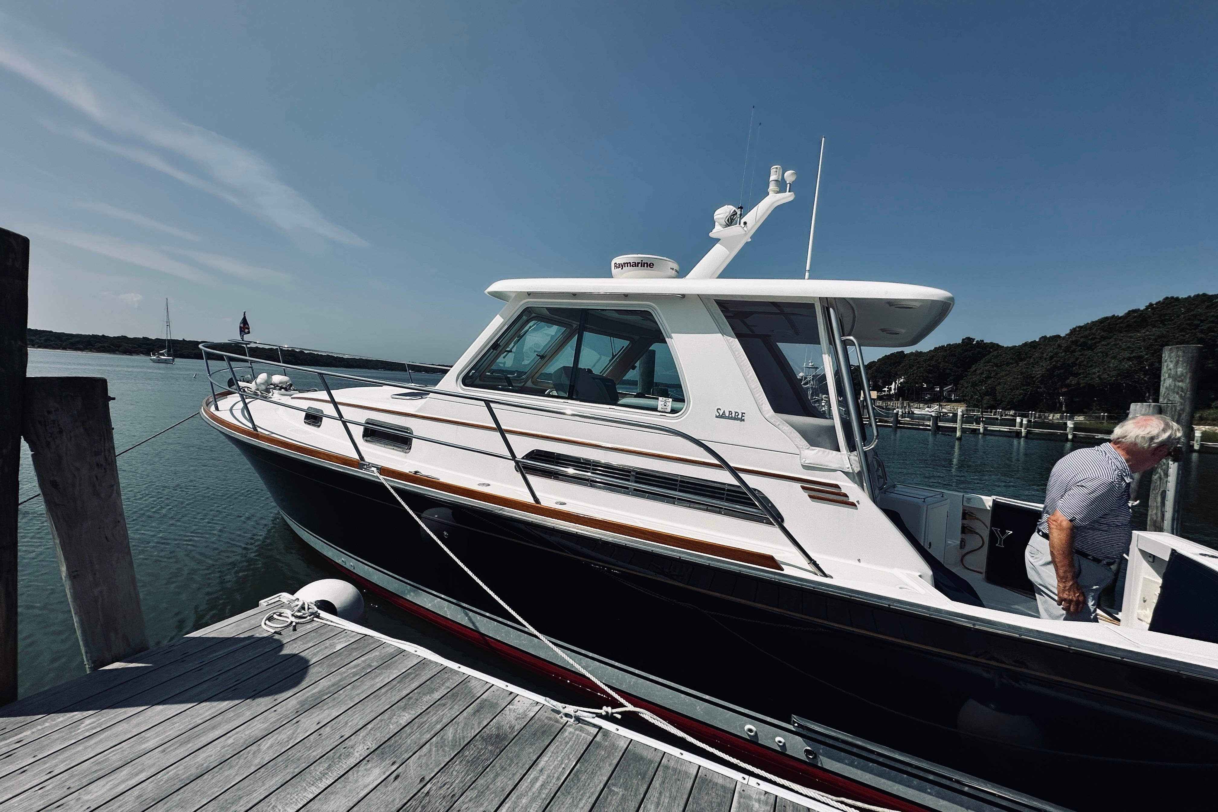 2007 Sabreline 34 Express yacht docked at a marina on a sunny day.