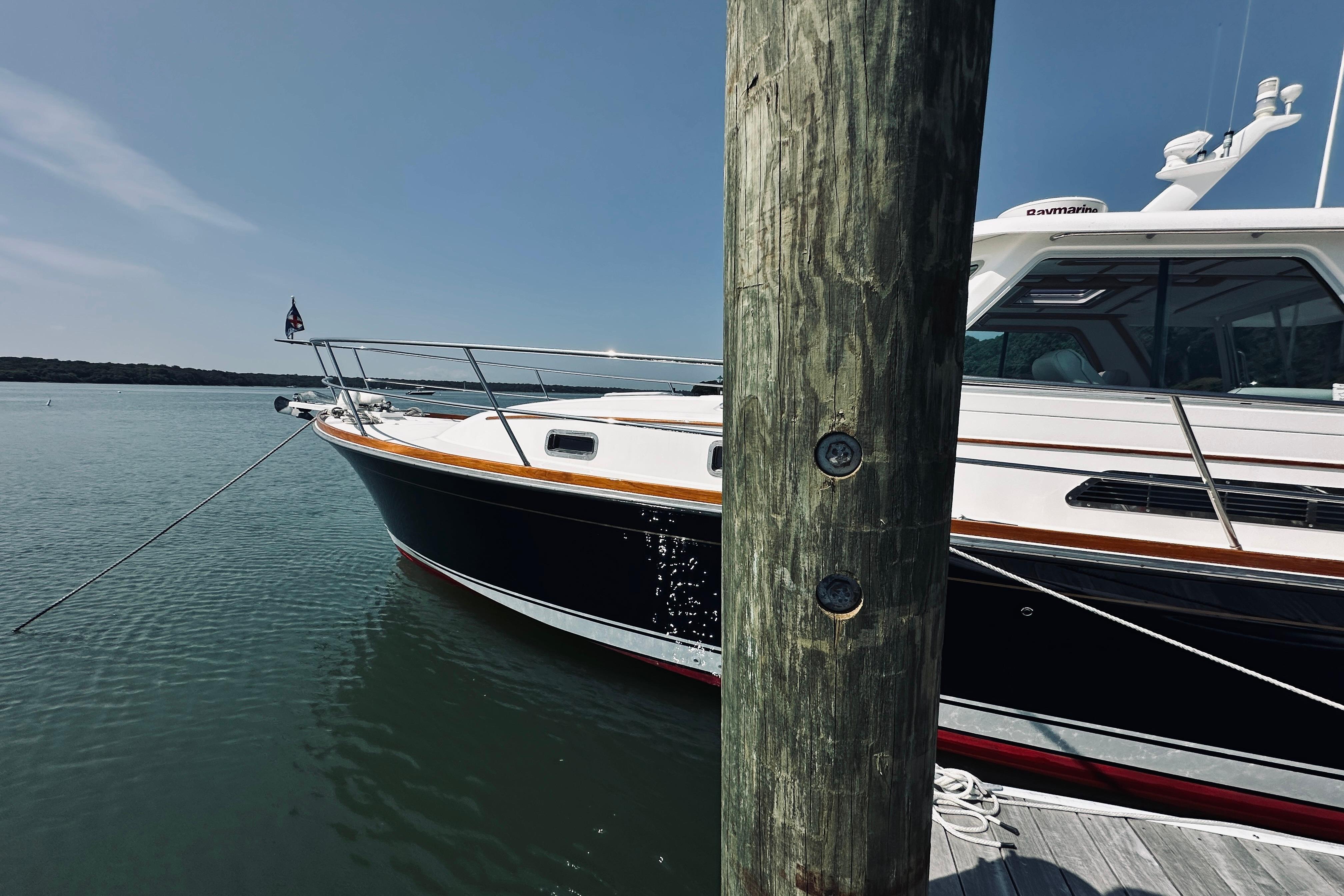 2007 Sabreline 34 Express yacht docked on calm water, sunny day.