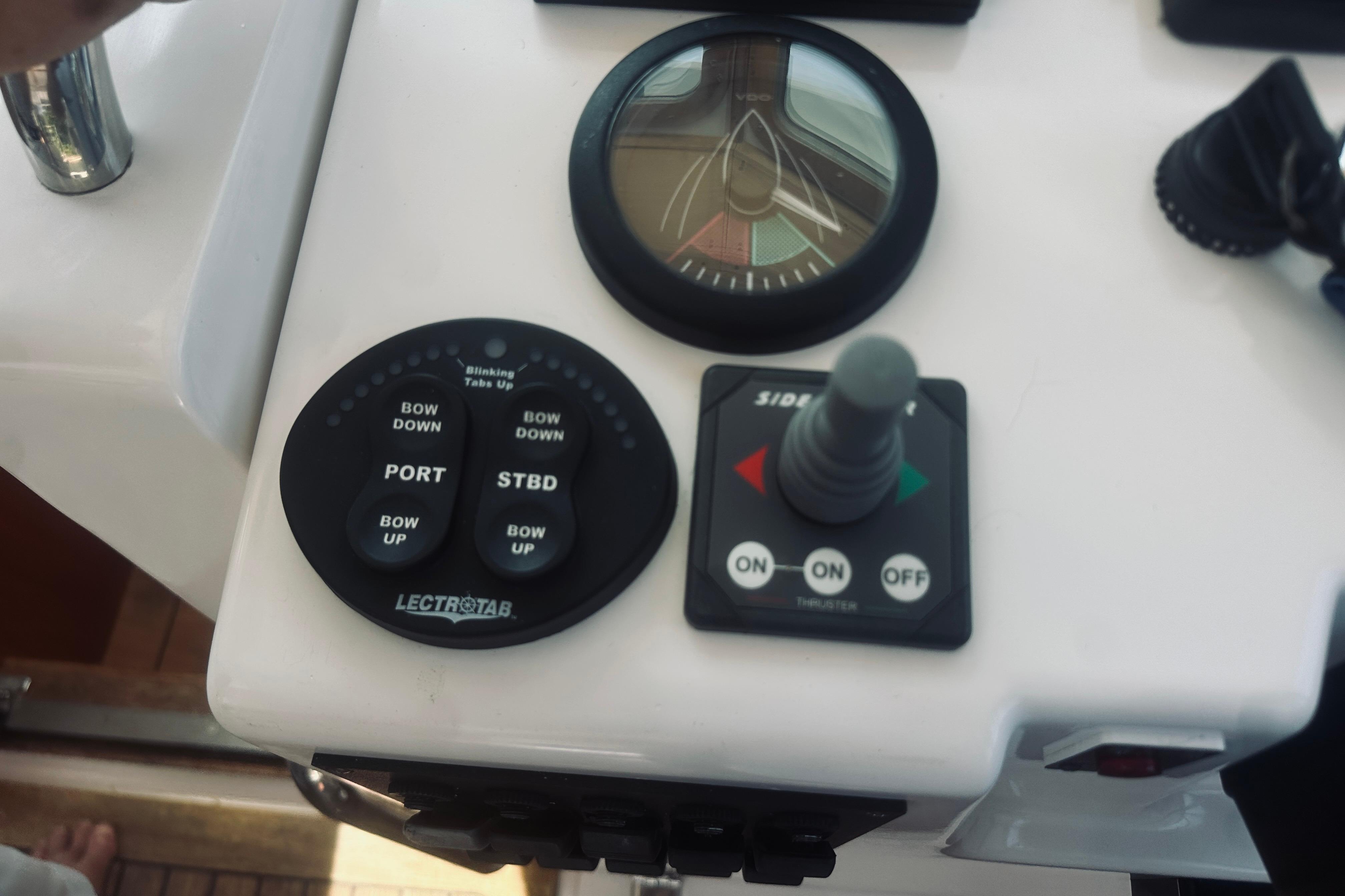 Control panel of a 2007 Sabreline 34 Express boat with trim and thruster controls.