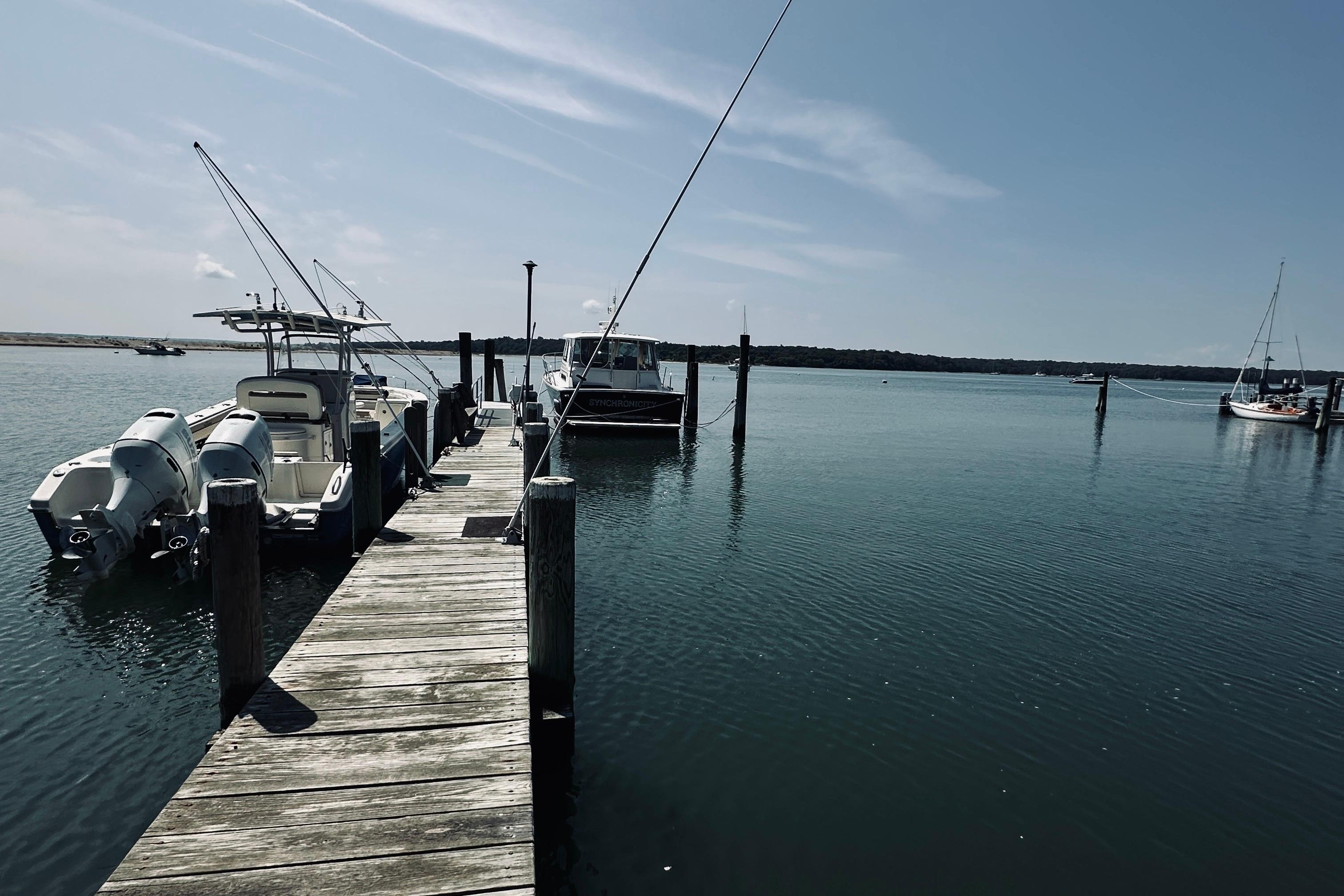 Docked boats at a serene marina, featuring a 2007 Sabreline 34 Express.