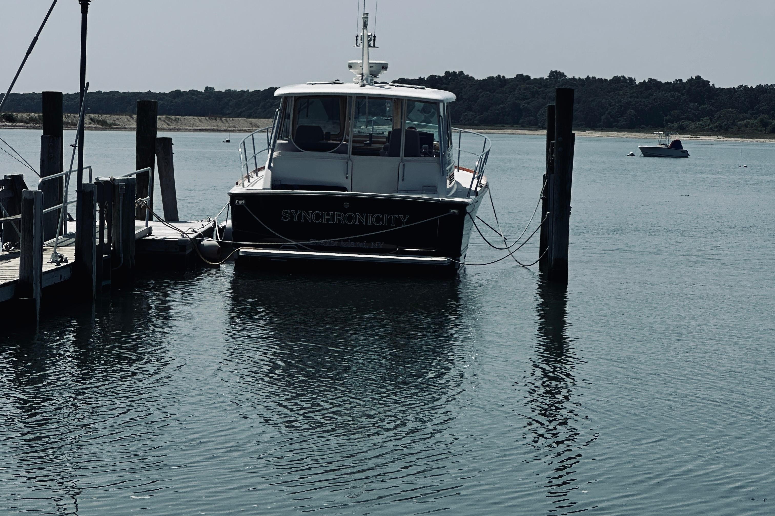2007 Sabreline 34 Express boat docked in calm waters, named u0022Synchronicity.u0022